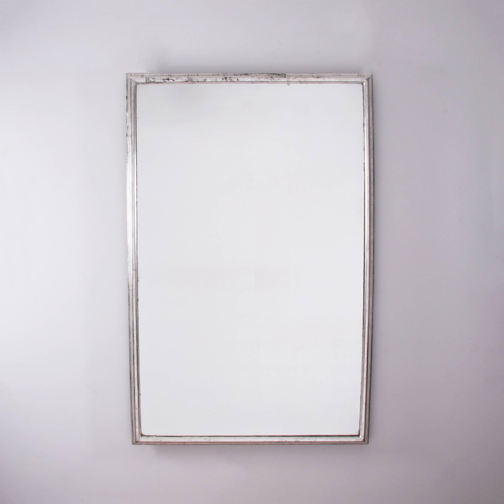 A stunning and elegant silver leaf mirror with a simple bistro style frame. The outside edge of the frame is painted black. Original plate with minor foxing.