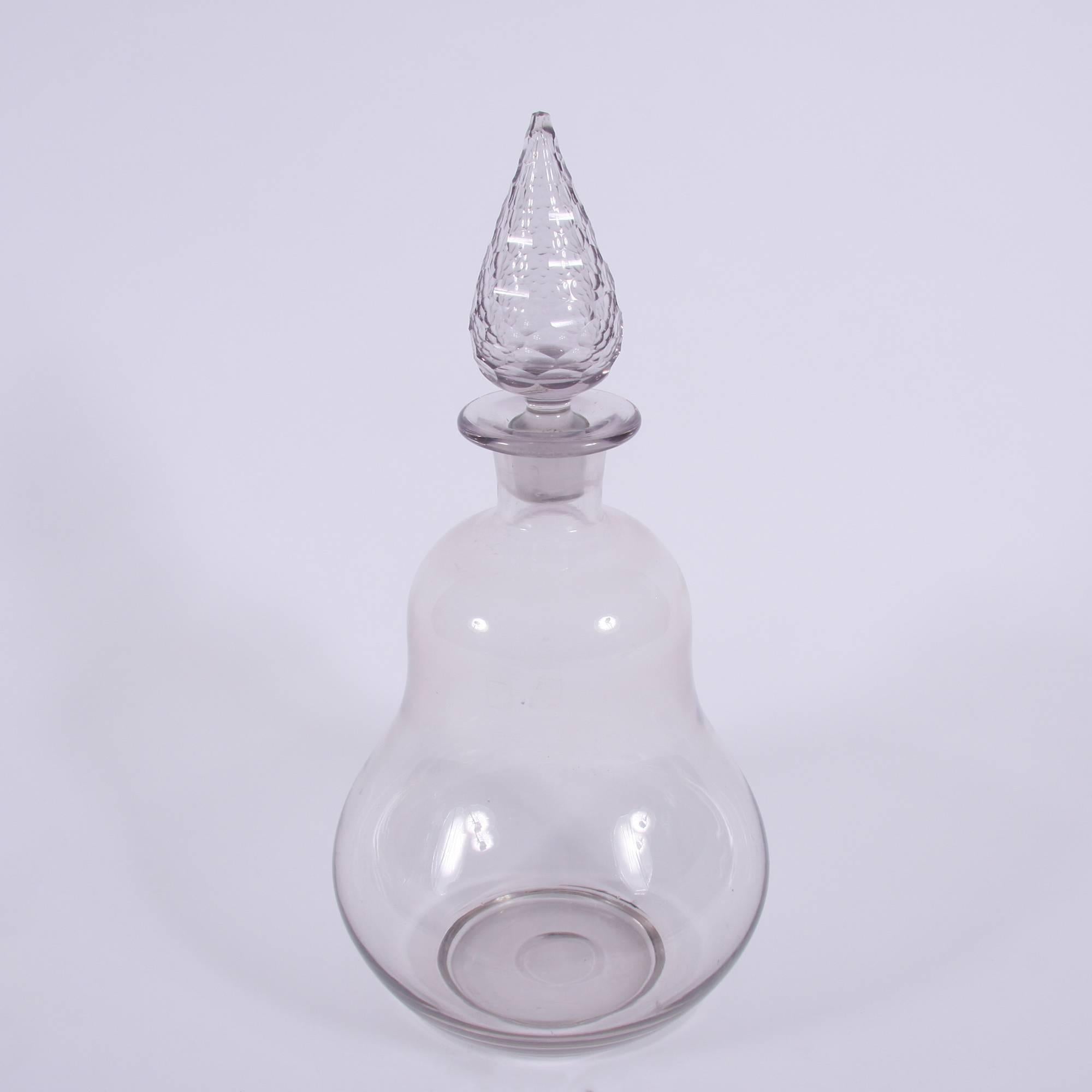 Belgium, 19th century

A large display jar form an apothecary's shop. This large glass jar has a slight lilac tint to the glass and a cut-glass pine shaped stopper.