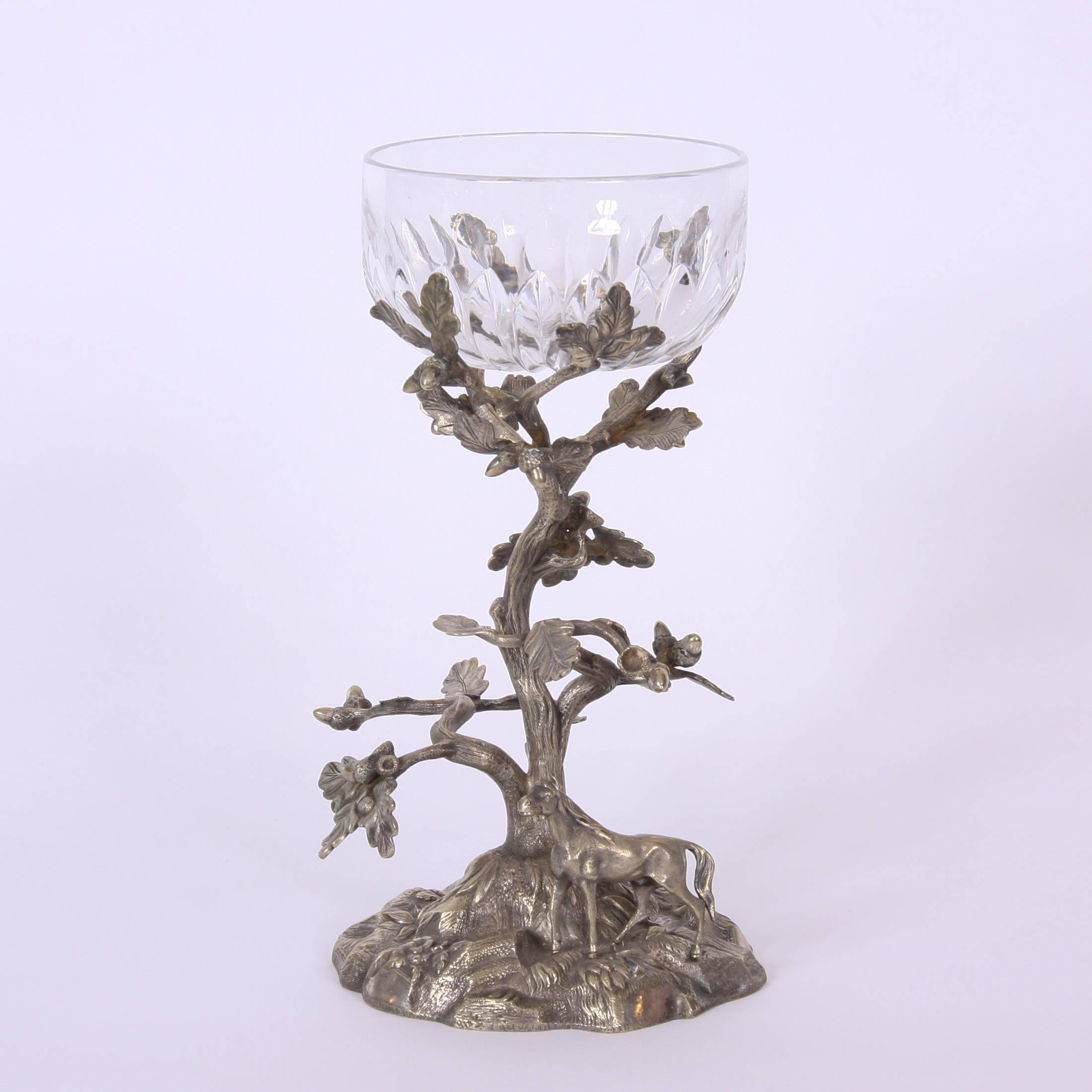 English, early 20th century

A lovely cut glass bon bon dish on a silver plated stand depicting a pastoral scene, with superbly detailed acorn tree and horse. The dish rests on the stand.