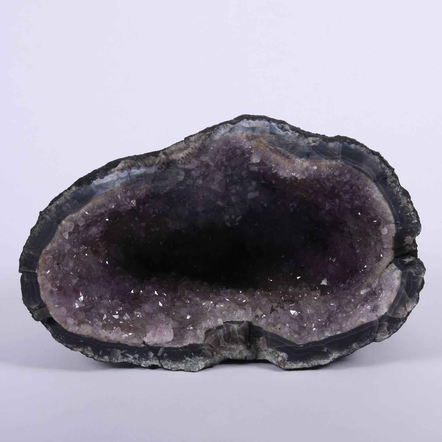 This is a fantastic natural amethyst geode cave (also known as cathedrals or churches). Geodes are rocks that seem plain on the outside but when opened reveal a cavity in the middle filled with beautiful crystals. The general scientific consensus is