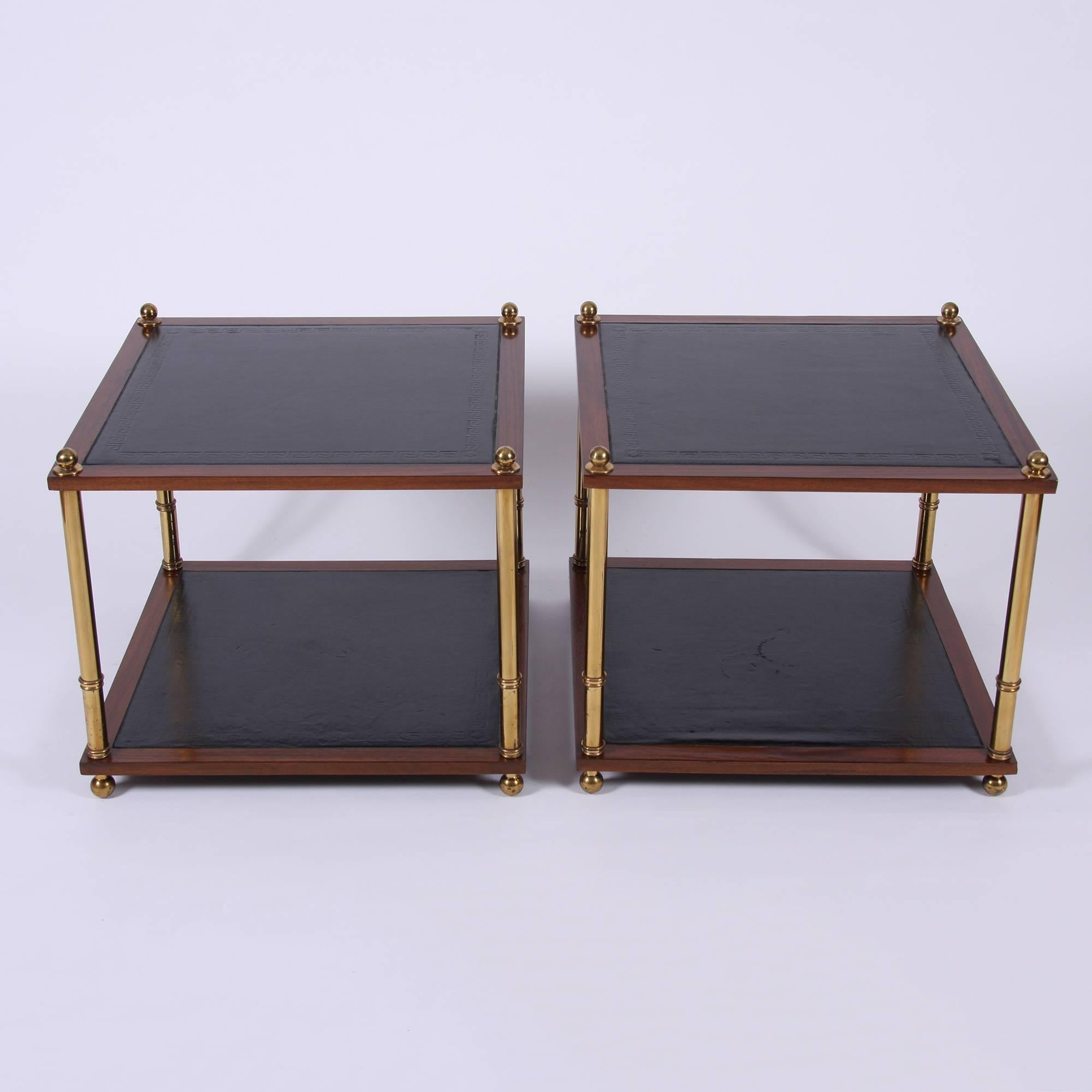 French, circa 1960

A pair of two-tier brass and hardwood side tables. Two-tier with black leather tops with a Greek key design.
