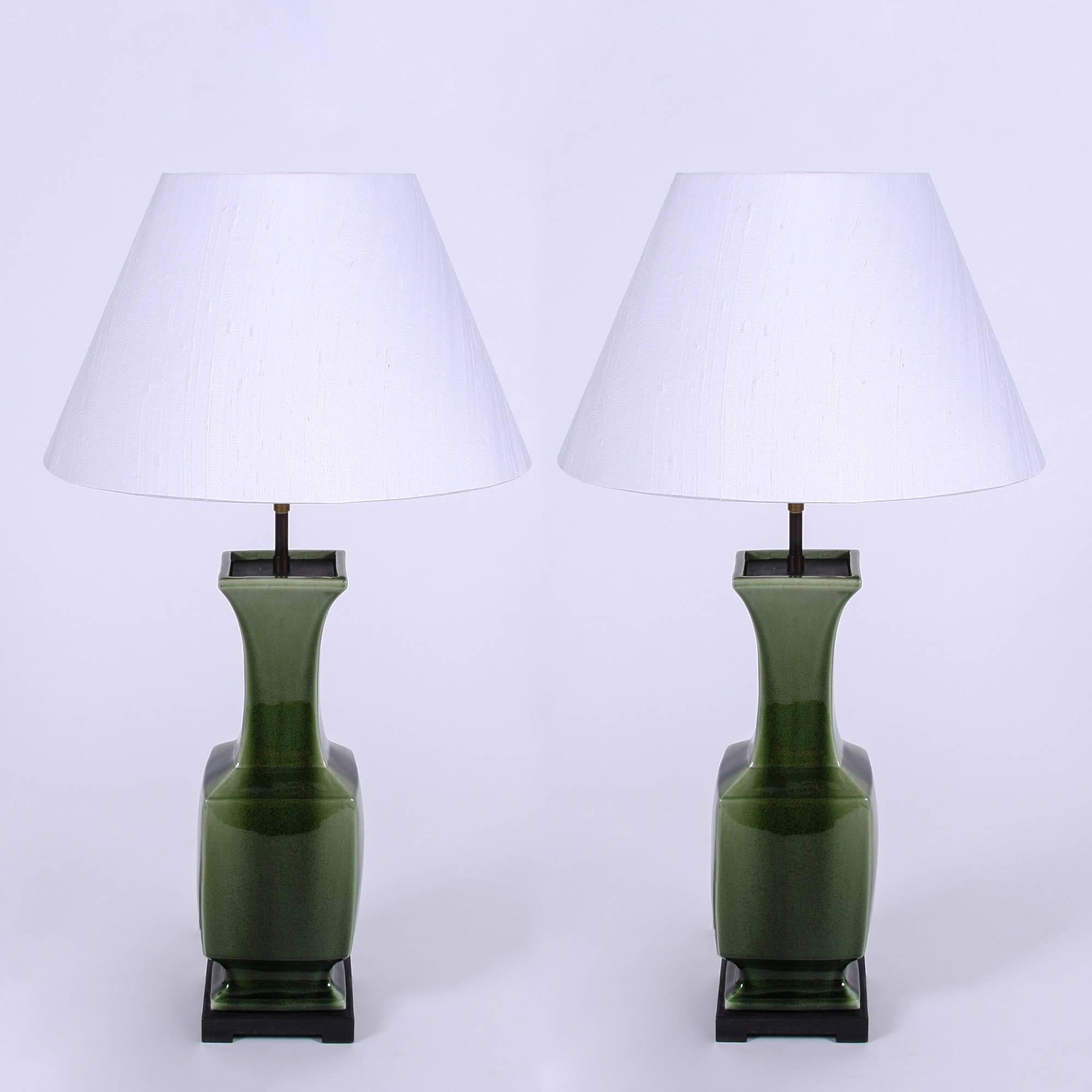Portuguese c.1960

Pair of green ceramic lamps with ebonised wood base and stunning two tone glaze finish. Handmade silk lampshapes. Rewired and PAT tested. 