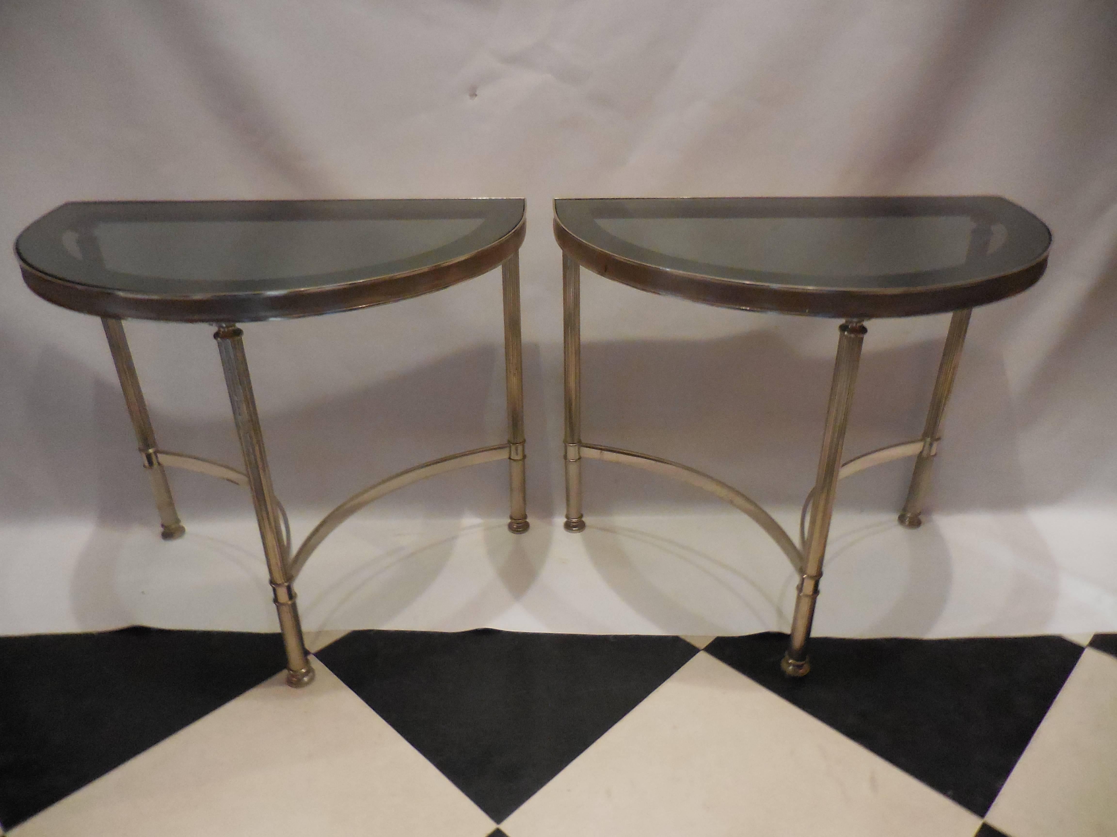 Pair of Mid-Century Modern demilune side tables with fluted polished steel legs and smoked grey glass. In good condition.