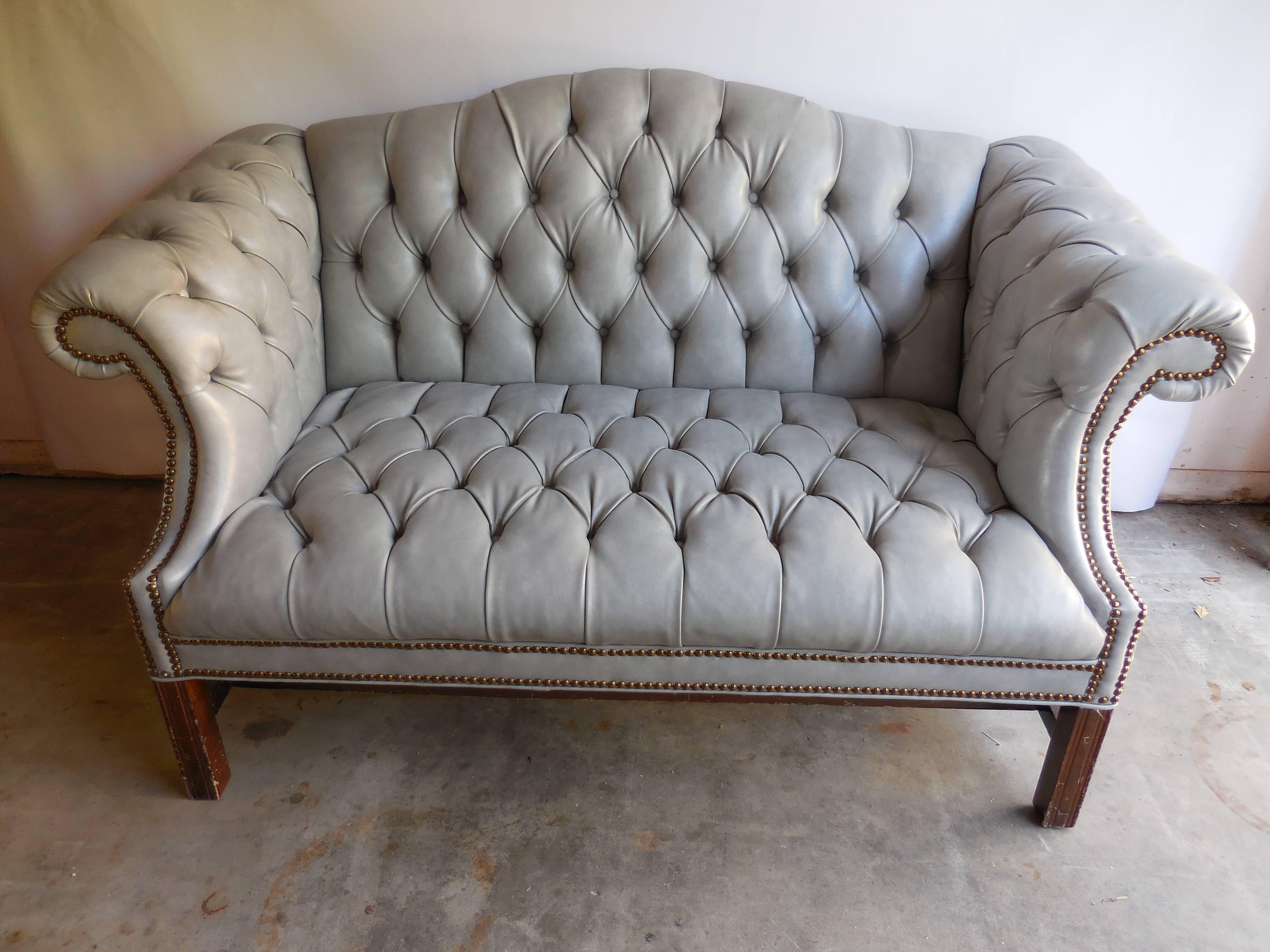Chippendale tufted leather settee with nailhead trim, circa 1950. In excellent condition.
