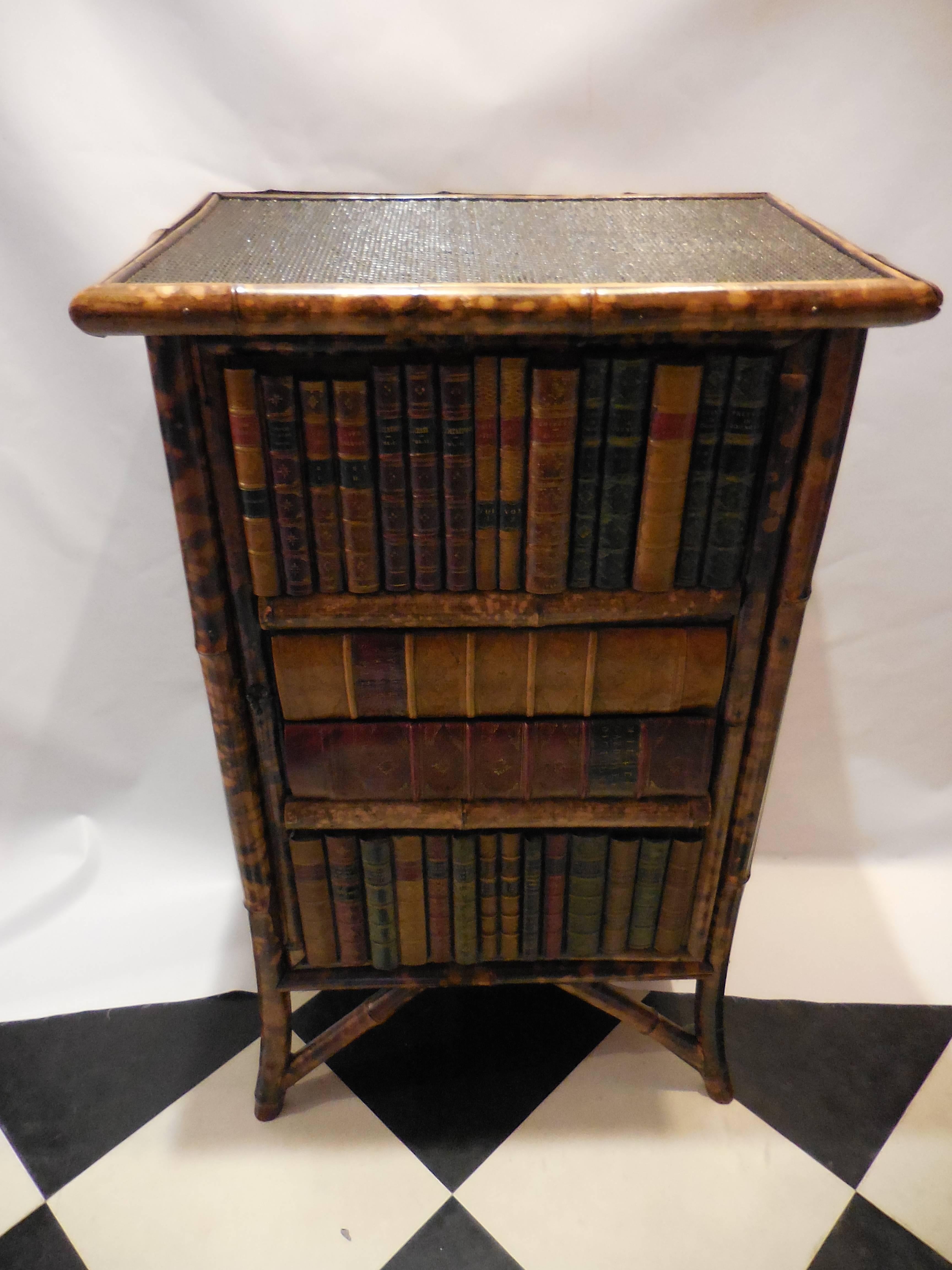 Bamboo cabinet with faux library books. In excellent condition, circa 1940.