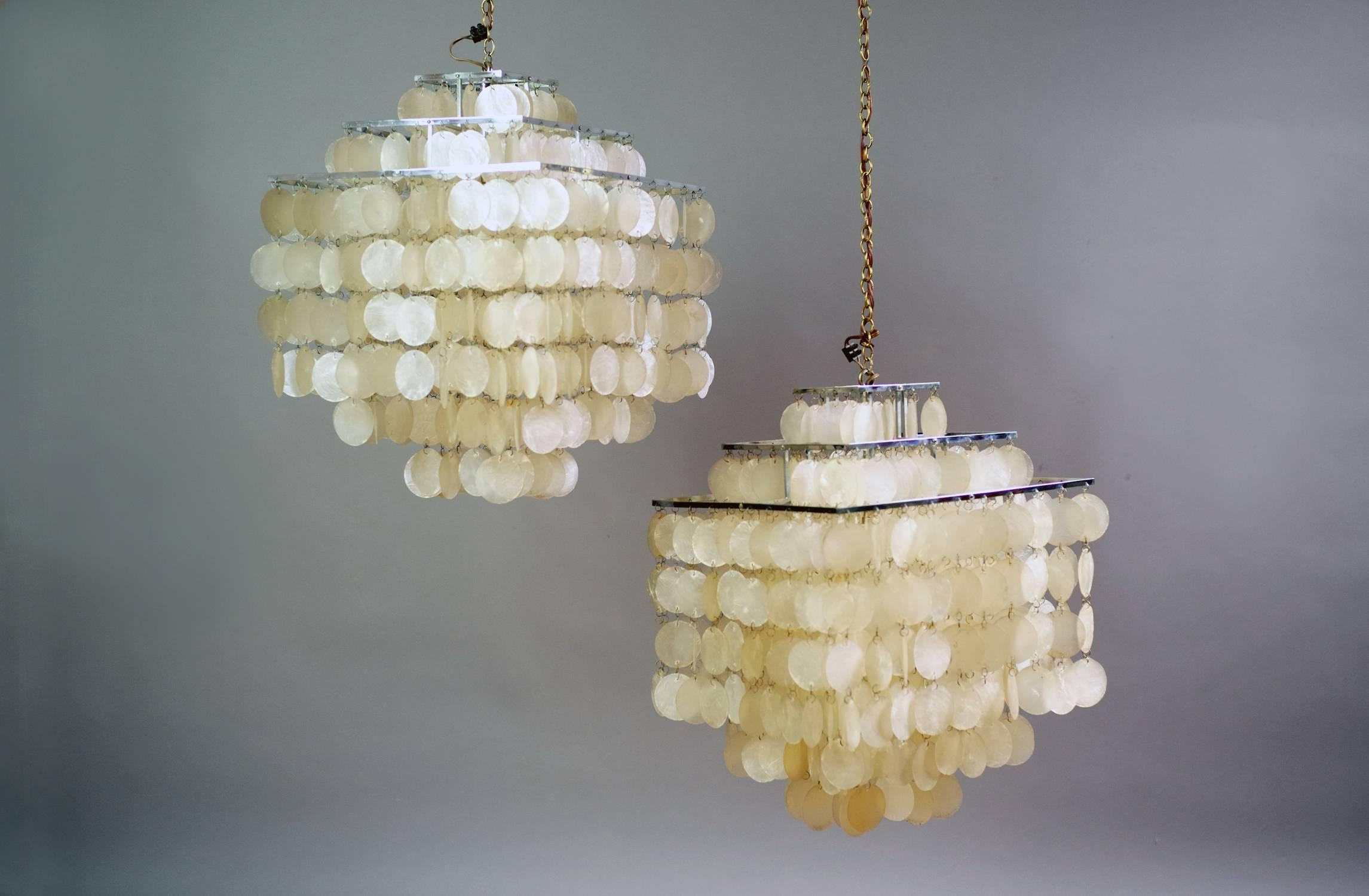 This pair of model Fun pendants was designed by Verner Panton for J. Lüber. They were produced in Switzerland, circa 1964. This model has a quadratic shape made from chromed metal and three tiers of mother-of-pearl discs. The height including the