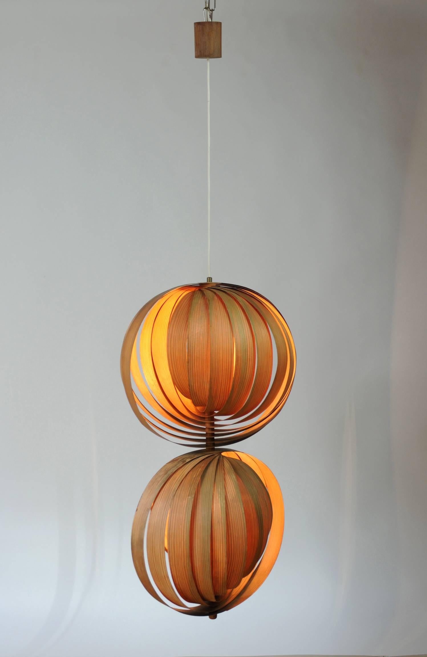 A pendant lamp with two spiral spheres made from pine wood leaves and designed by Hans Agne Jakobsson for Markaryd, Sweden during the 1960s. The spheres are centered around chromed steel circles. The spacing of the leaves can be adjusted at will.