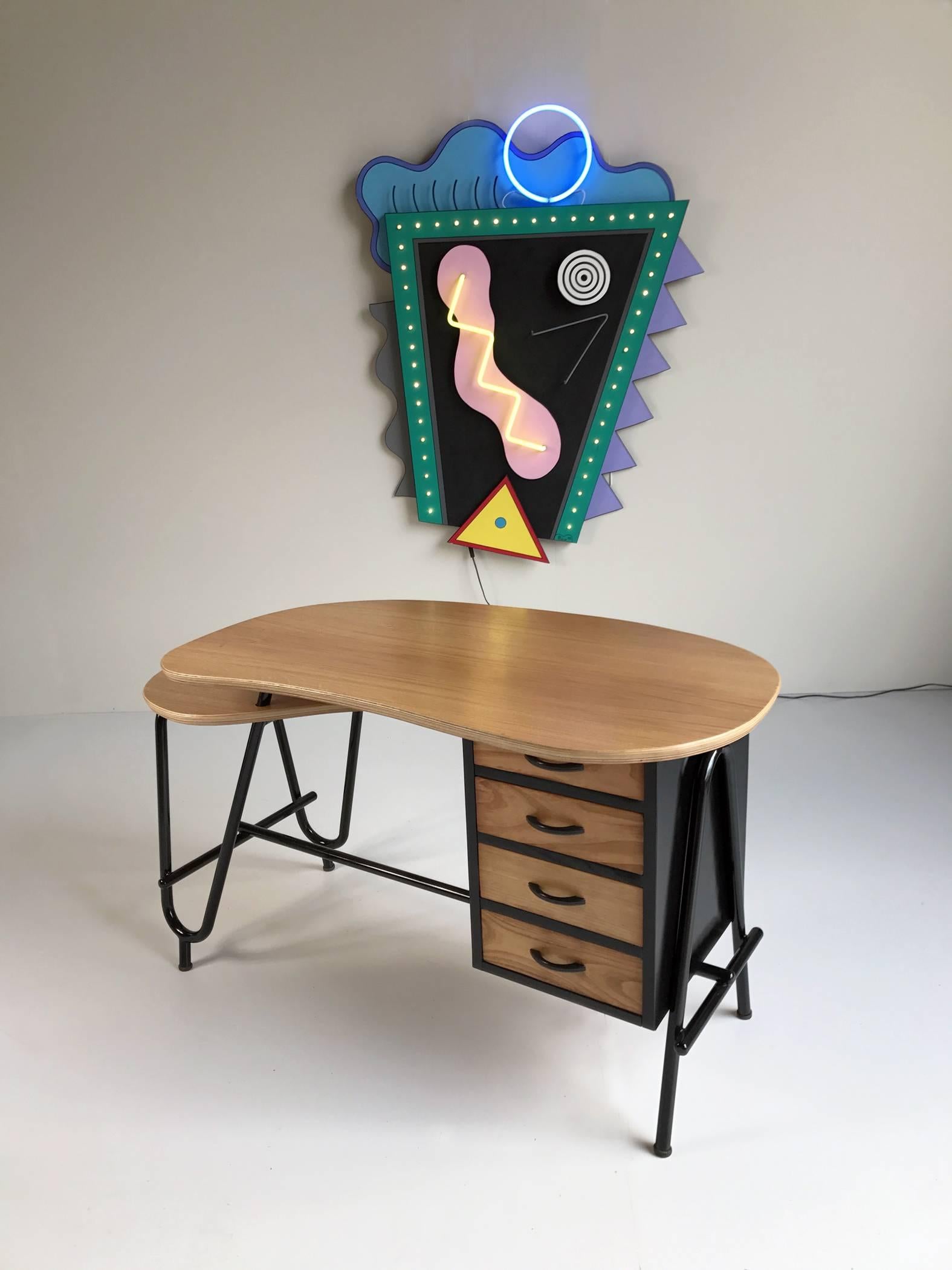 Beautiful desk with double tray by Robert Charroy for Mobilor, France, 1955.
Black lacquered tubular frame, free-form trays in oak plywood, oiled varnished finish.
  