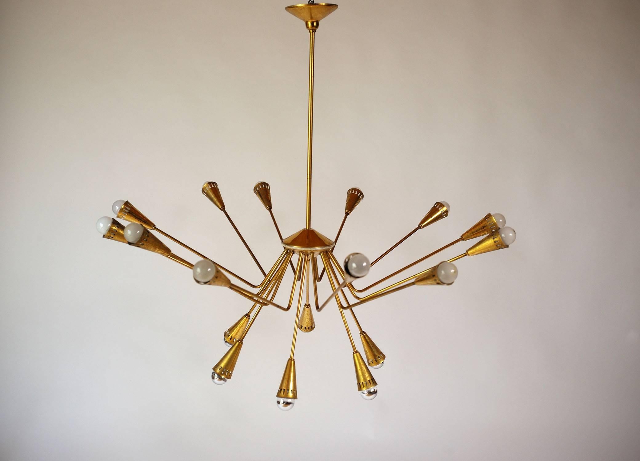 Rare golden brass eighteen-light chandelier by Oscar Torlasco for Lumi, Italy, 1950. Perforated bulb covers in drops of water.
Beautiful state of origin, electricity restored to norms.