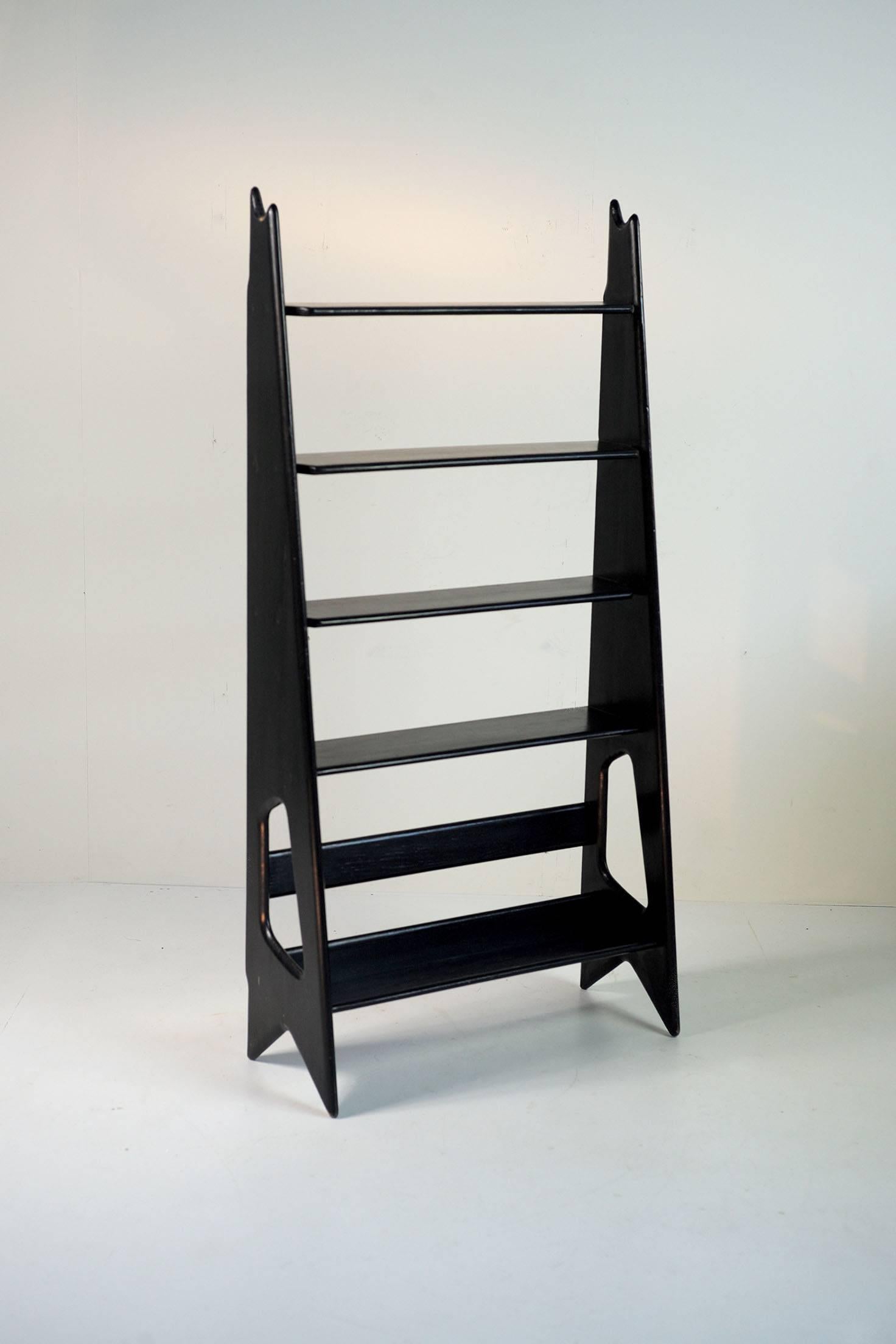Pierre Cruège (1913-2003), blackened / waxed oak bookcase, Éditions Formes / France, 1950. 
Pupil of René Buthaud then René Prou, Pierre Cruège is an important player in the reconstruction (1945-1955). This free-form library is a very good example