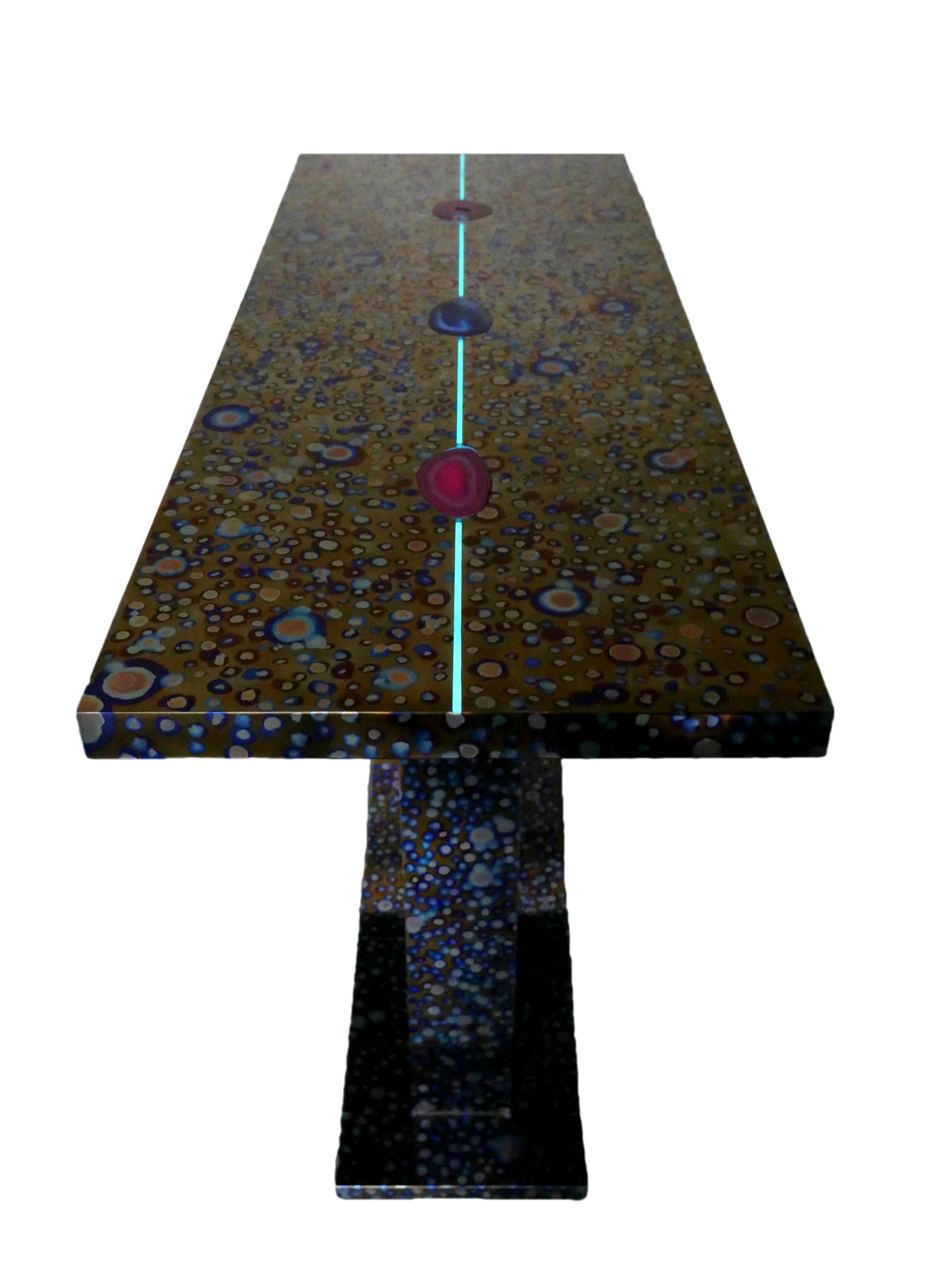 The COSMOS console by Xavier Mennessier, in made of hand patinated titanium with fluorescent agate inlay.
Signed and numbered.
Custom sizes and patinas available. Please, contact us!
This console may be in stock. Check with us for