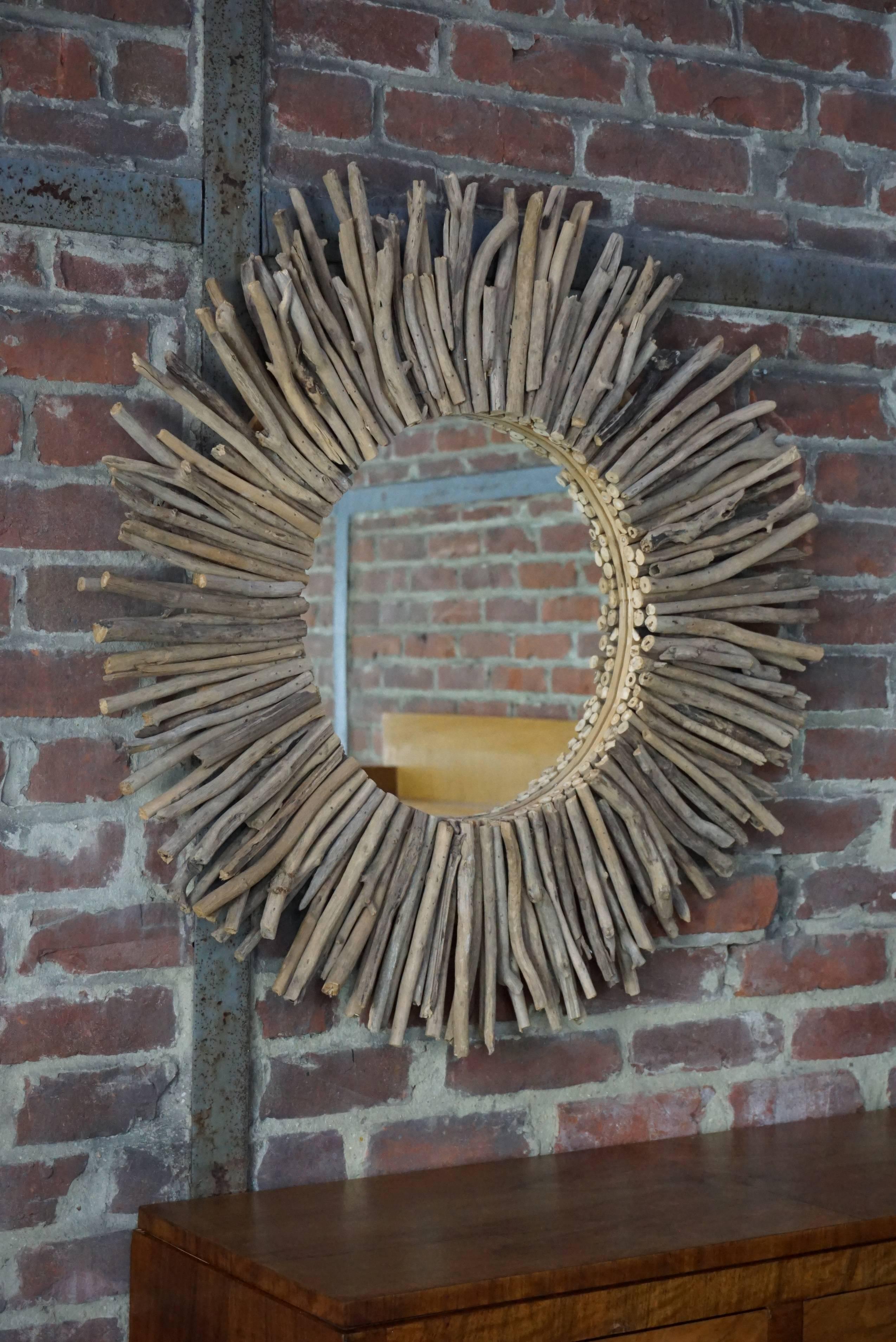 Pretty patina for this large driftwood sunburst mirror. Measures: Total diameter 90cm, mirror diameter 40cm.
     