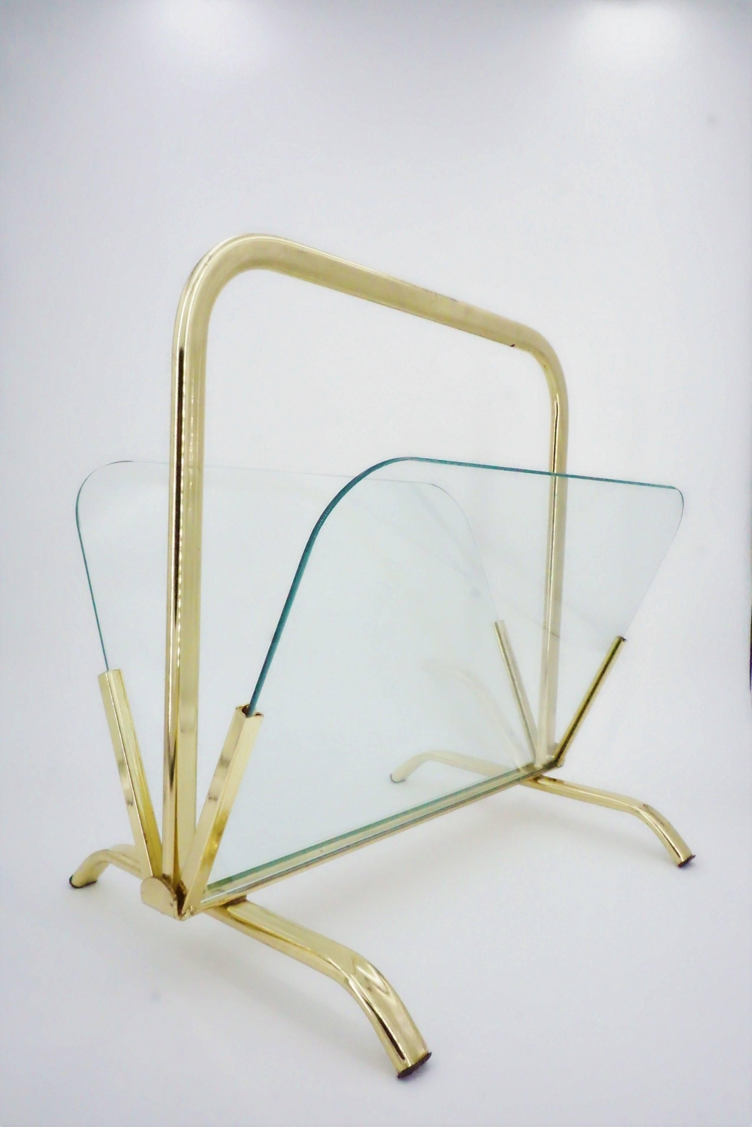 Glass And Brass Magazine Rack in Hollywood Regency style. Elegance and transparency for this superb gilt metal magazine rack and glass wall. All in excellent condition!