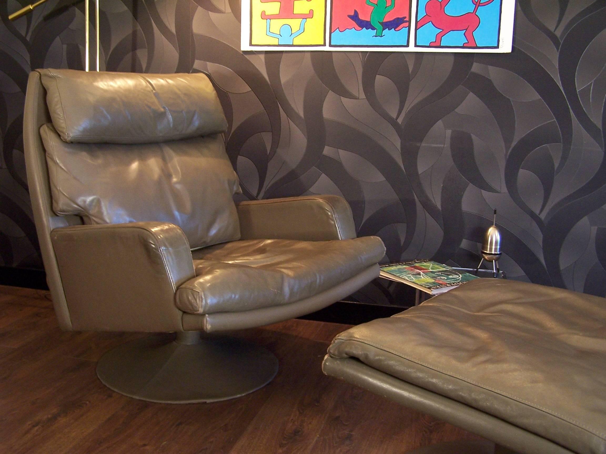 This leather swivel chair and ottoman has a nice patina, and the cushions are stuffed with goose feathers.