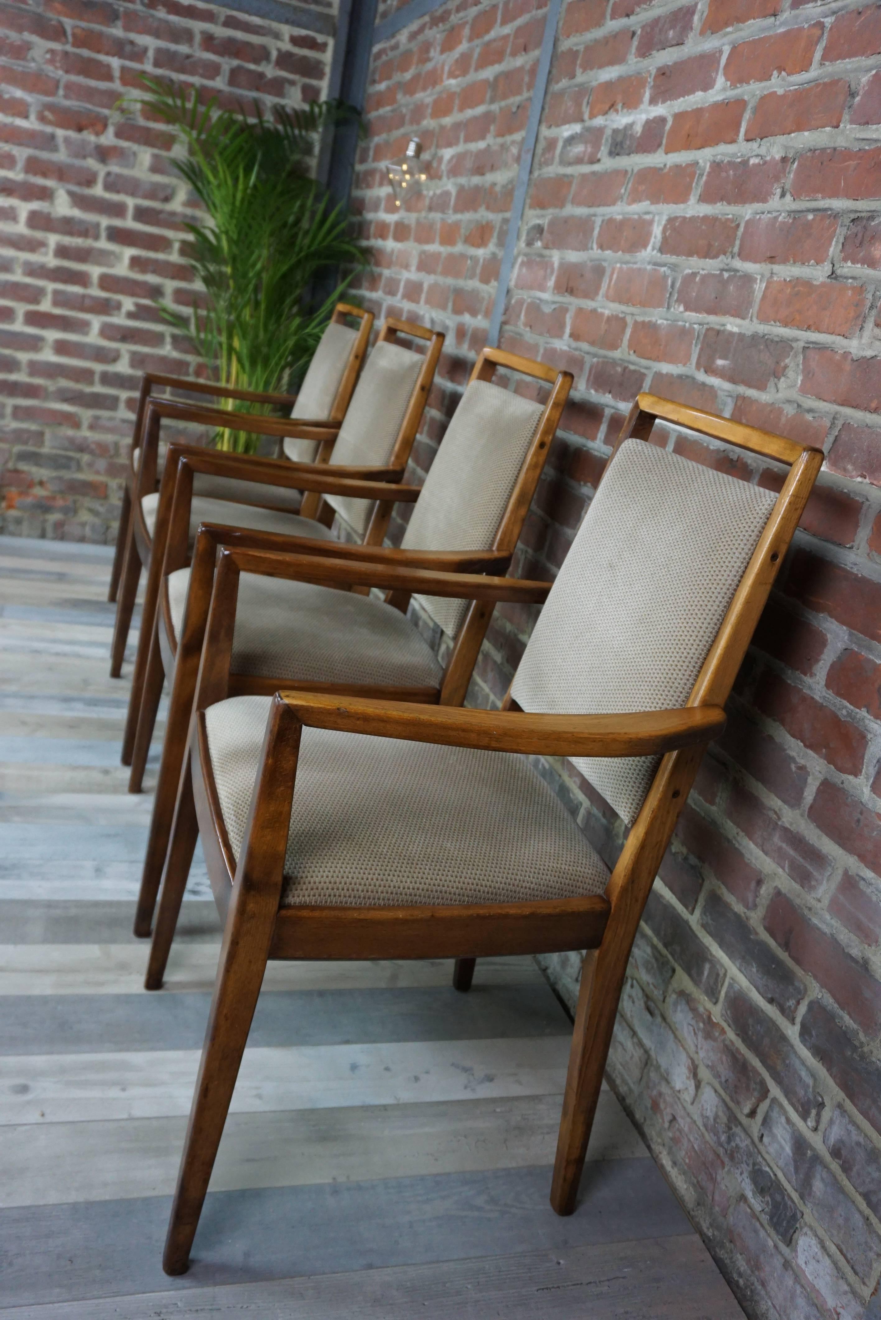 Set of four Scandinavian chairs with armrests, comfortable, elegant. Beautiful workmanship with a nice work of wood, curved at the level of the armrests. Seat and fabric in very good condition.