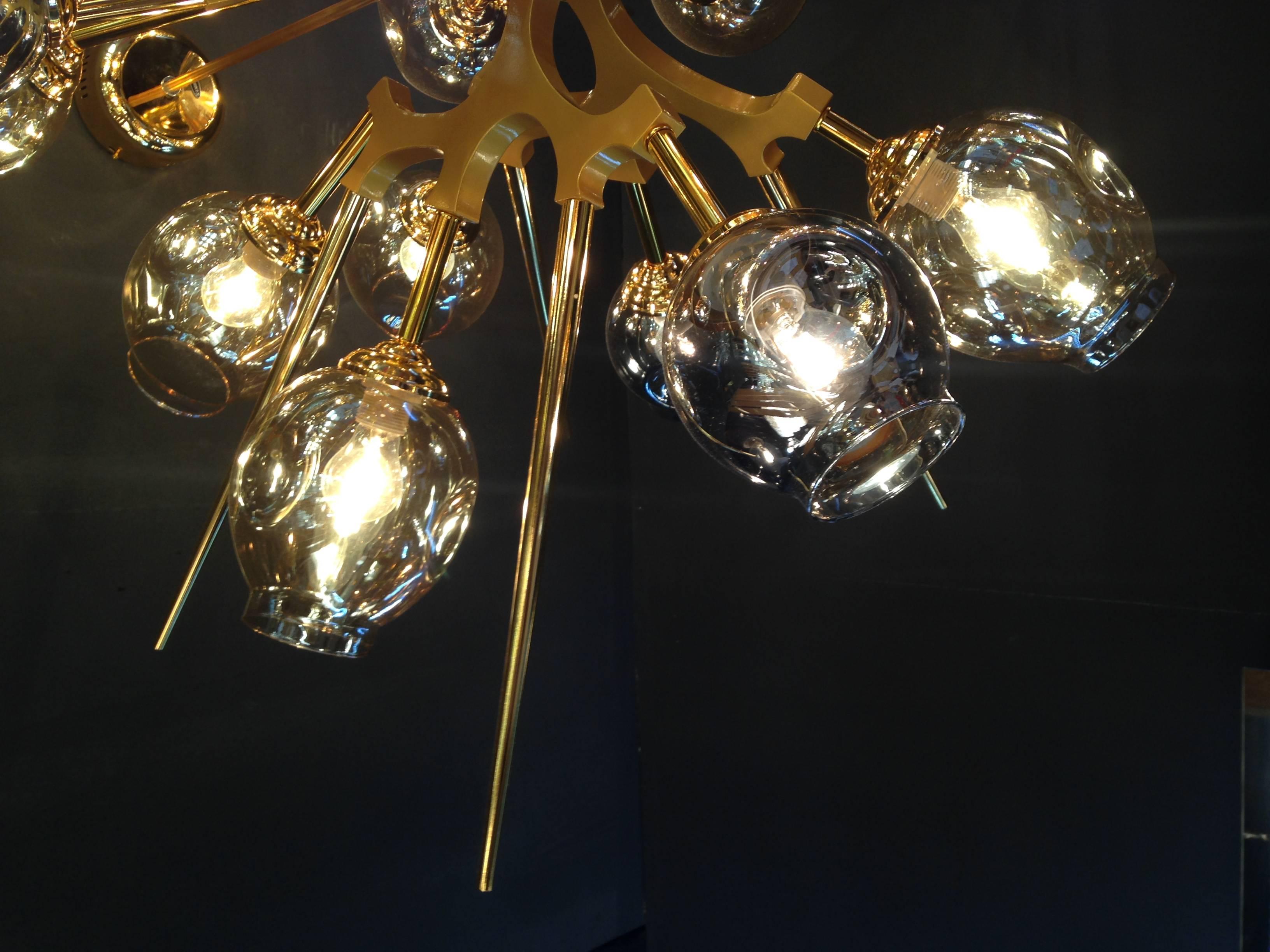 Masterful metal chandelier, 18 bulbs of warm light. Very graphic and Atipyque