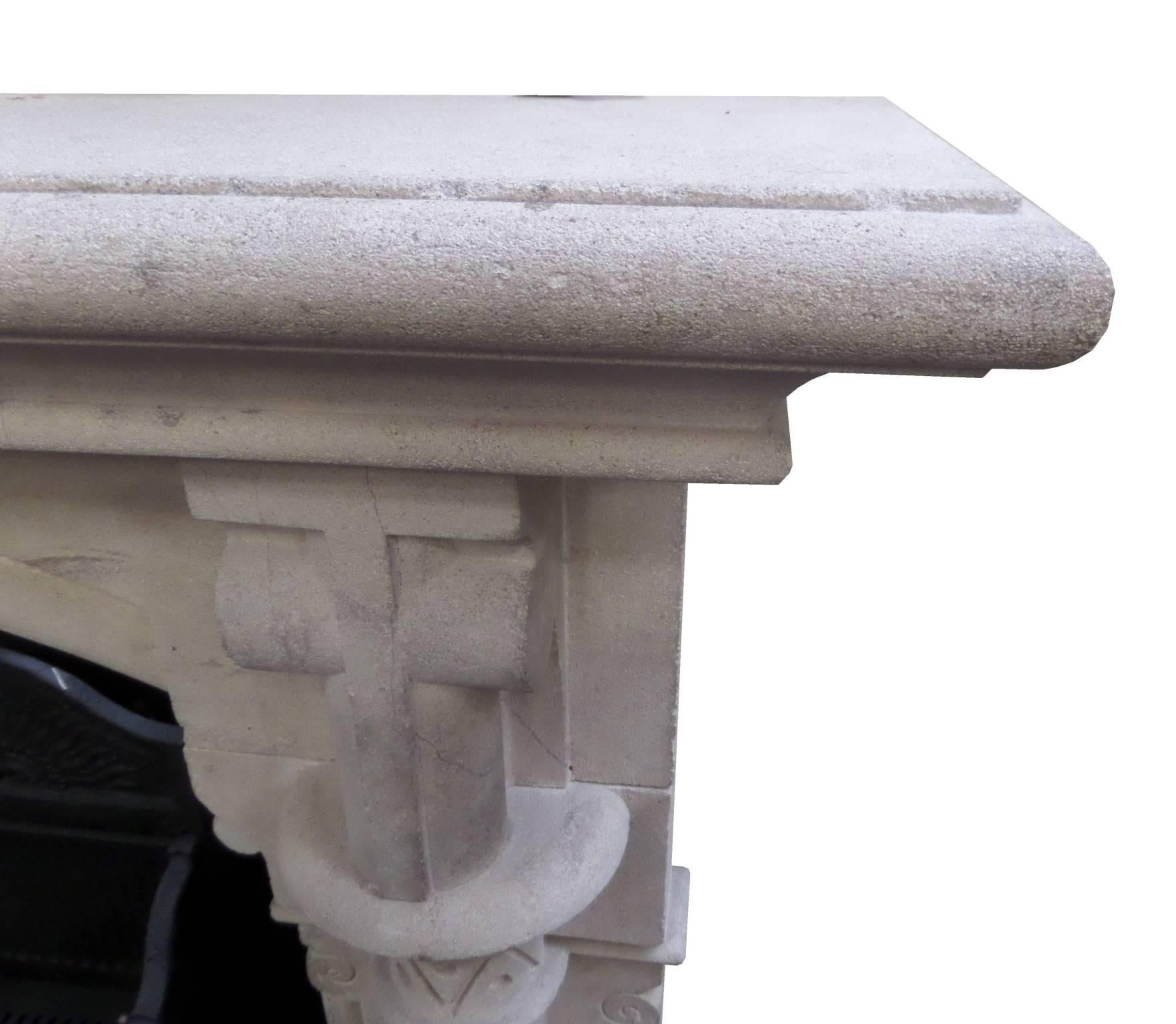 Antique restored Victorian stone fire surround with a large mantel supported by two pillars with bold Gothic features, circa 1850 from a vicarage in Leicestershire.