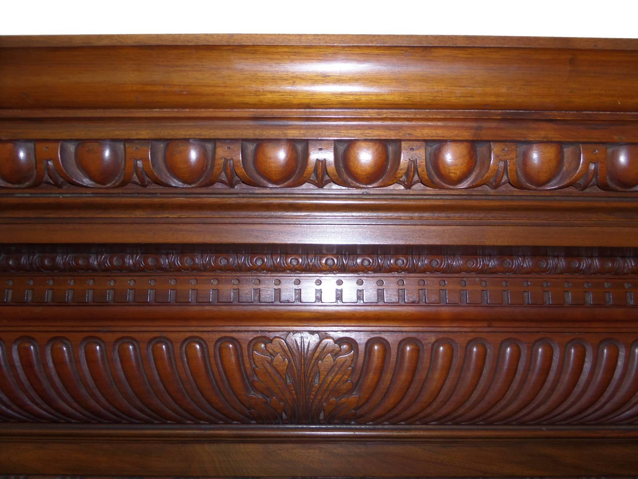 Antique restored large Regency / early Victorian walnut and mahogany wood surround. Lots of hand-carved detail shown with a Georgian fire basket, circa 1815. From a large property in Windsor, London.