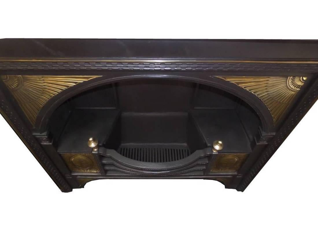 Antique restored Georgian brass adorned hob grate, restored to its original standard complete with original cast back and damper plate. Finished in a traditional antique black polish. The minimum width and height shown are to the pattern edge.