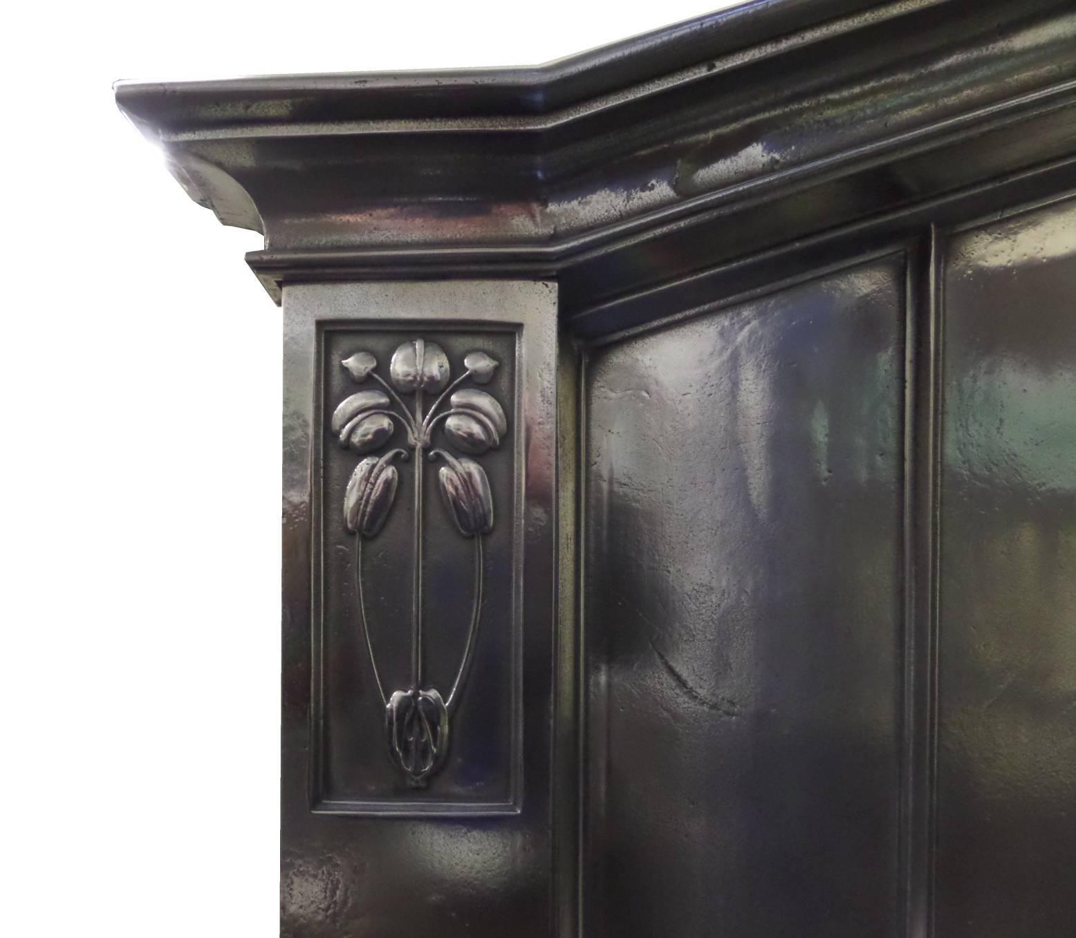 Antique restored Arts and Craft burnished (semi - polished) cast iron surround. This surround also has Art Nouveau design influence especially the floral cast patterns, circa 1905. The surround was purchased from a sea side villa in north Yorkshire,