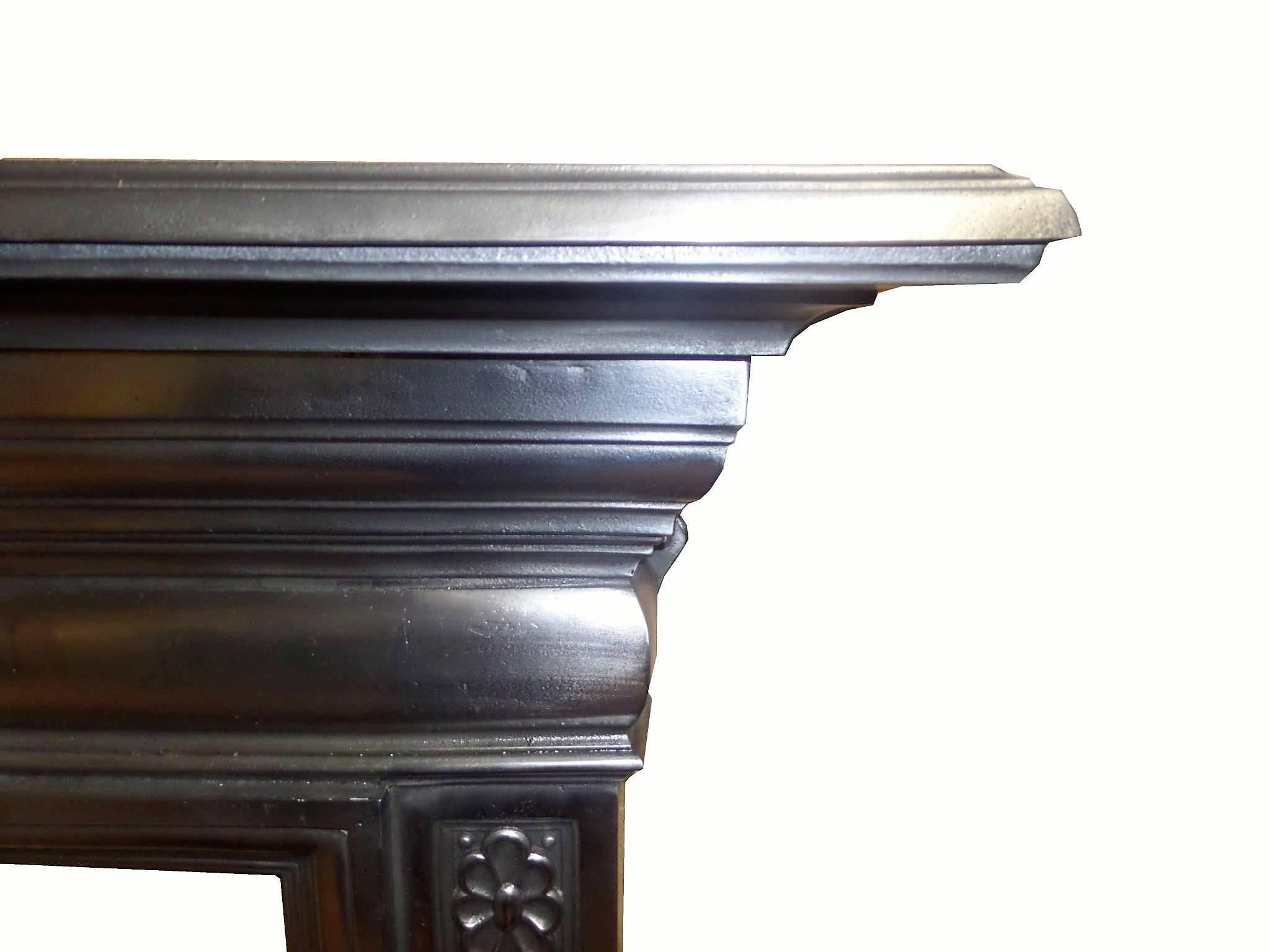 Antique restored burnished (semi-polished) cast iron surround. Delicate casting detail. Shown with two complete fireplace examples, circa 1901.