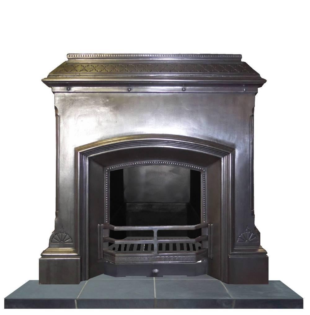 Antique restored Art Deco vintage 1930s burnished (semi polished) fireplace. Retro design with large opening and lots of interesting cast features. A unique fireplace. Complete with a grate and a reproduced ash cover.