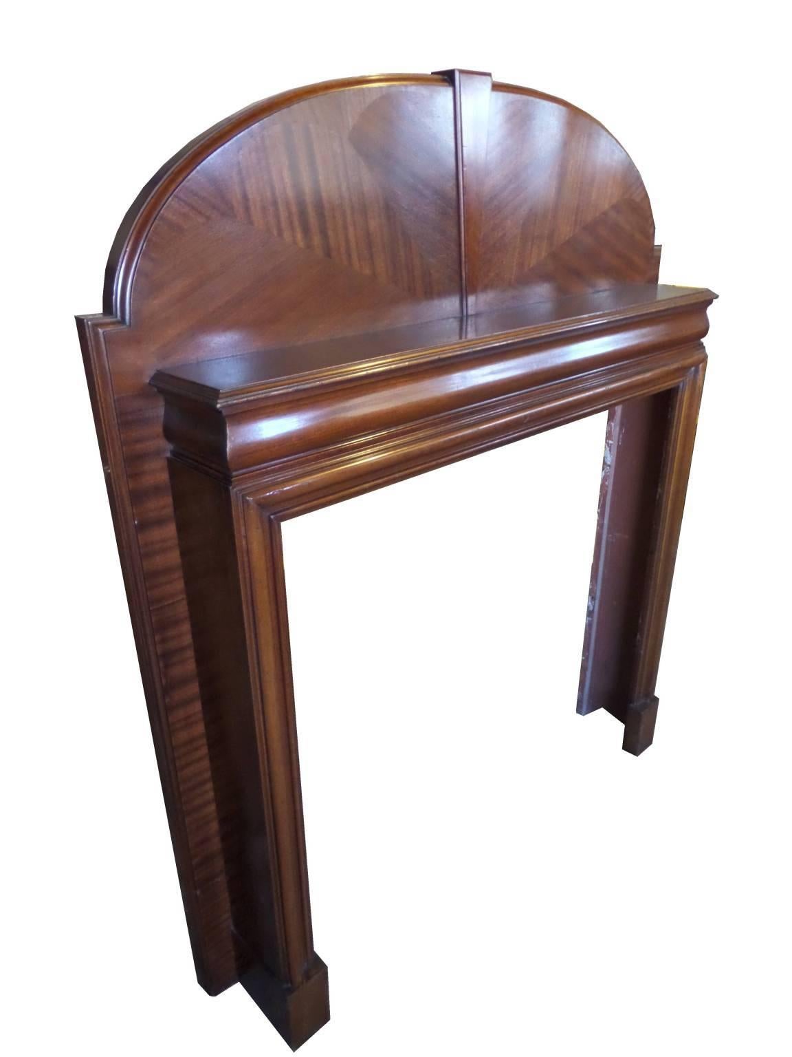 Antique restored Art Deco mahogany wood mantel. Deep rounded mahogany shaping typical of the art deco period. This mantel is shown with a retro Art Deco fire stainless insert also available on request and made to order.