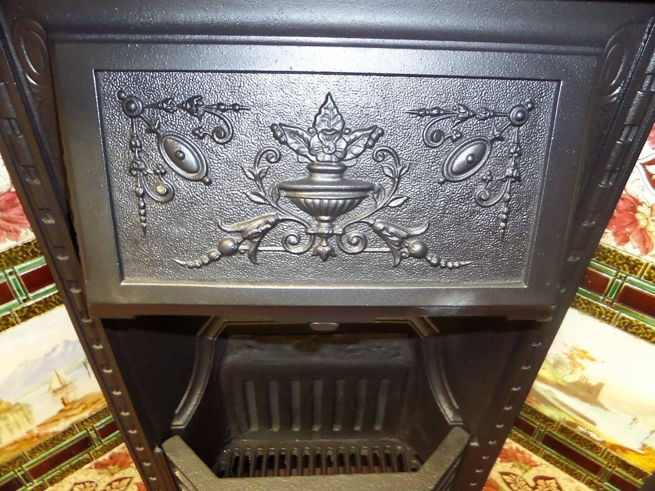 Antique restored 19th century Victorian cast iron fireplace Insert with its original Victorian tile set from a house in Leicestershire England. With its original solid fuel metal fire back and grate it is completed with a damper chimney isolation