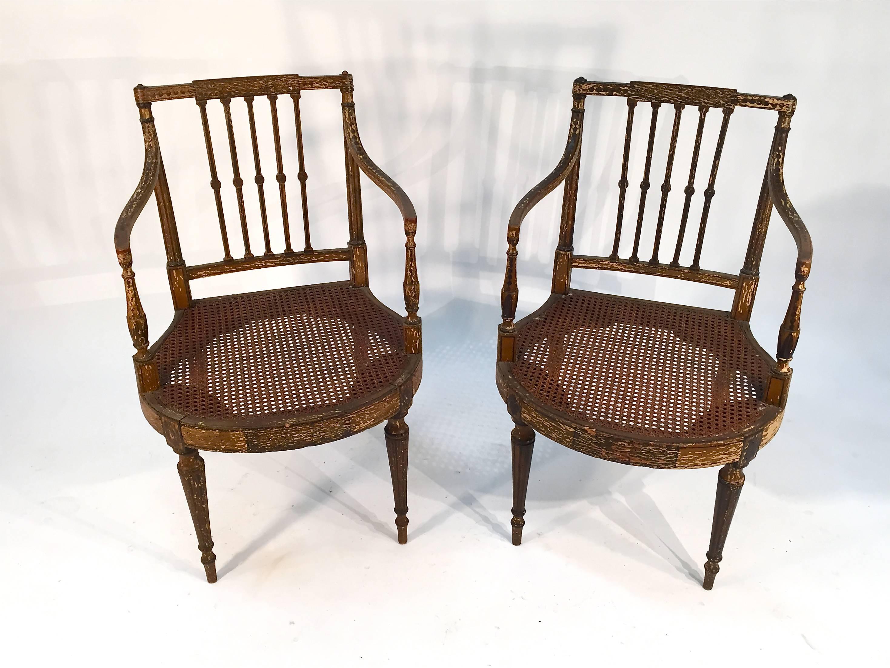 Pair of painted armchairs with cane seats. English, 19th century.