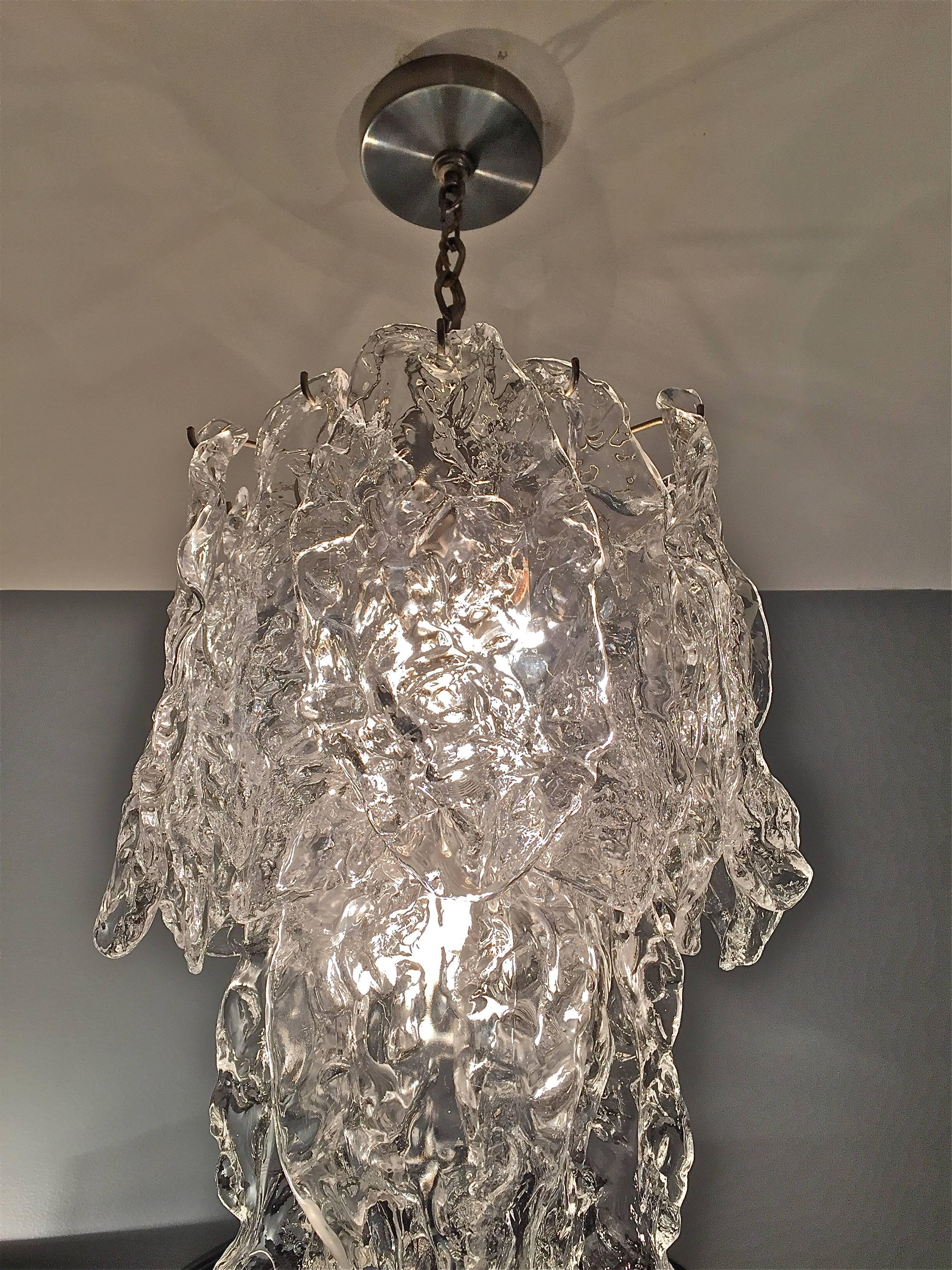 Stunning clear glass chandelier with a nickel plated armature by Mazzega, Italy, circa 1970s. Total length of the fixture including the ceiling cap is 29.5 inches.