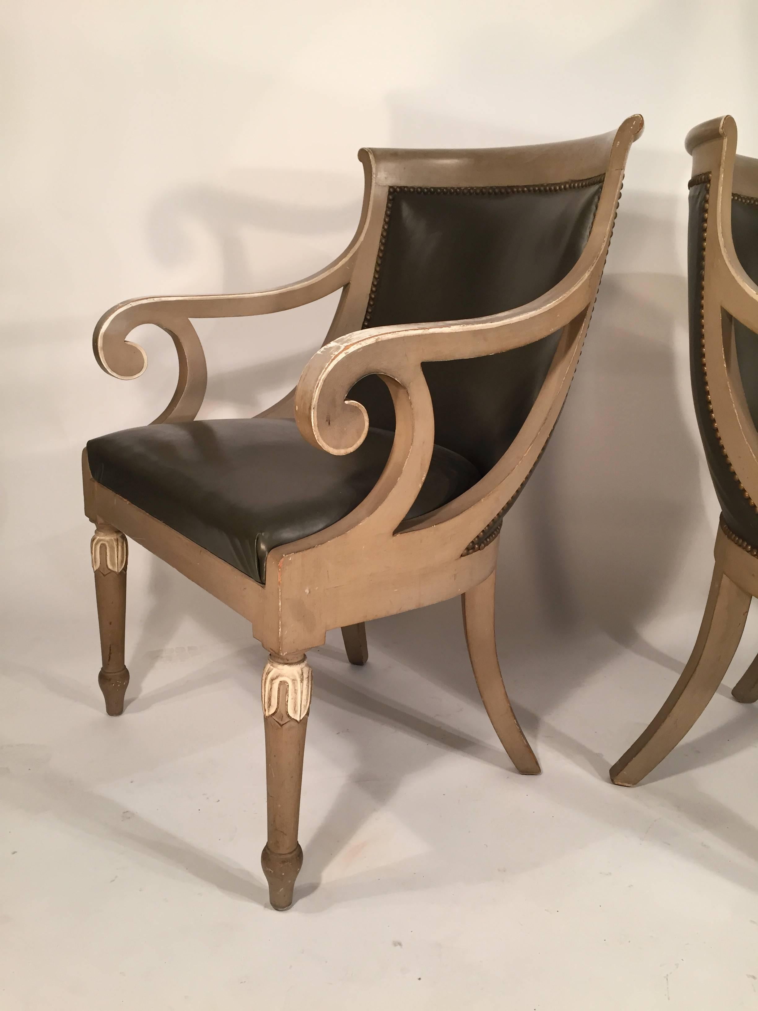 Pair of painted armchairs in the French Empire style. Faux leather upholstery is in good condition, American, 1940s.