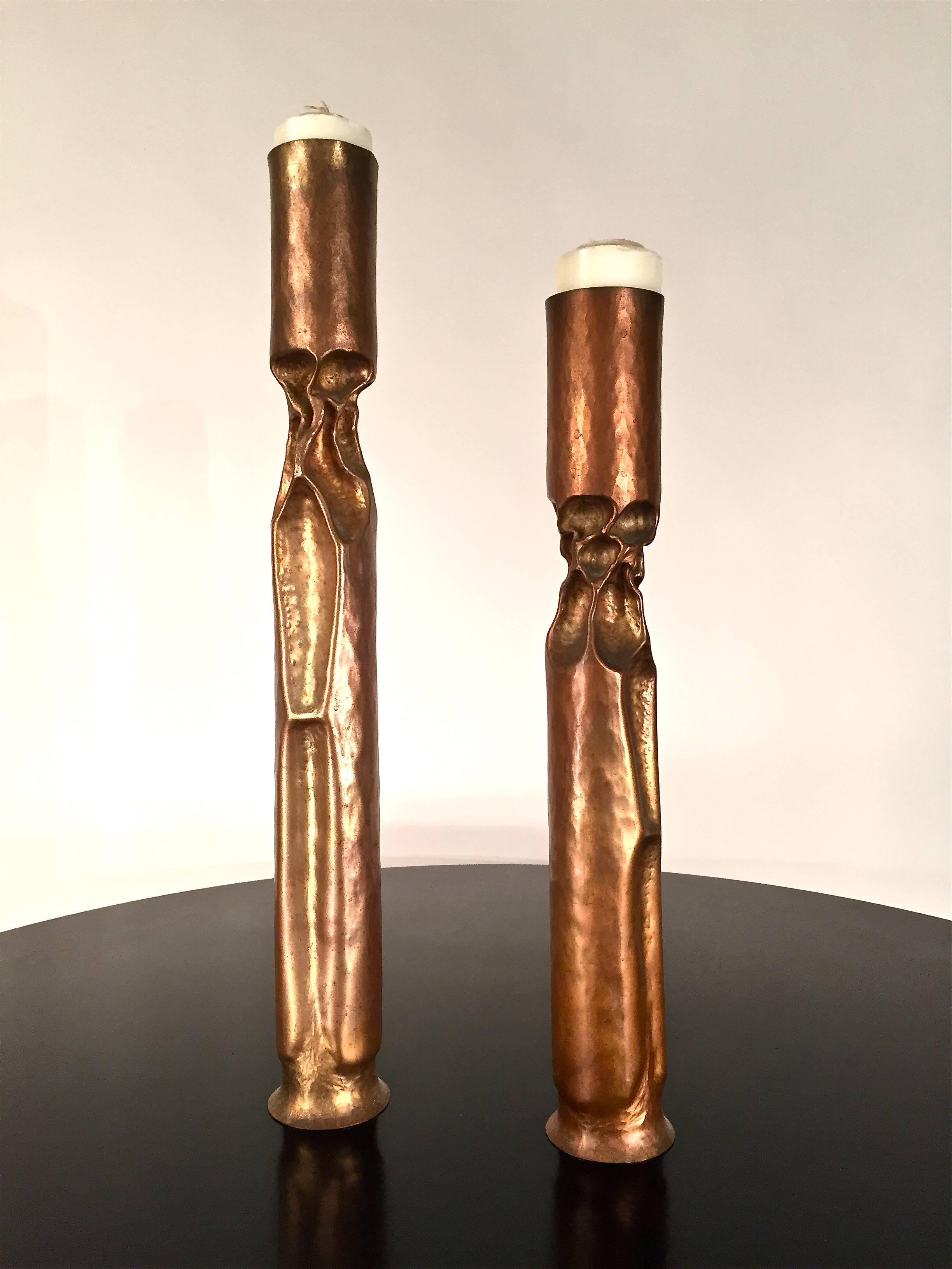 Two metal and copper candlesticks by Thomas Roy Markusen, American, 1980s.
