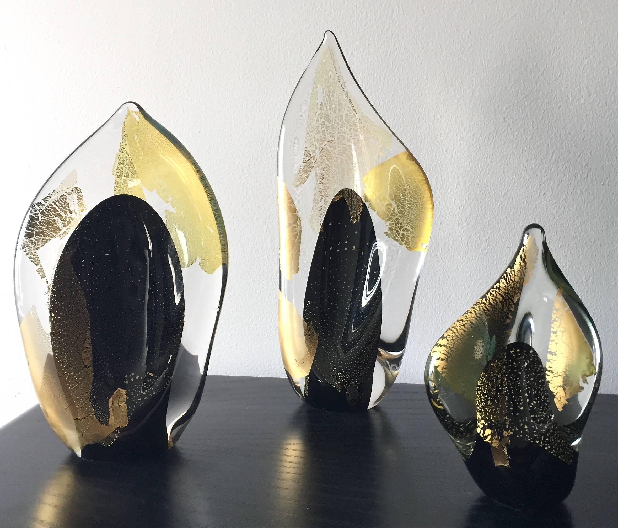 A set of three Randy Strong Dichroic flame art glass sculptures. All are signed R. Strong and dated 93. Measures: Sizes are 12.50 inches x 5.25 inches, 9.75 inches x 5.75 inches and 6.75 inches x 4 inches.