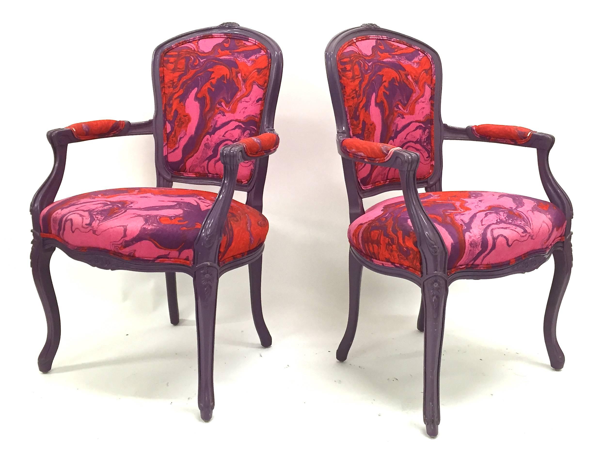 Pair of French style armchairs with purple frames and multi-color upholstery.