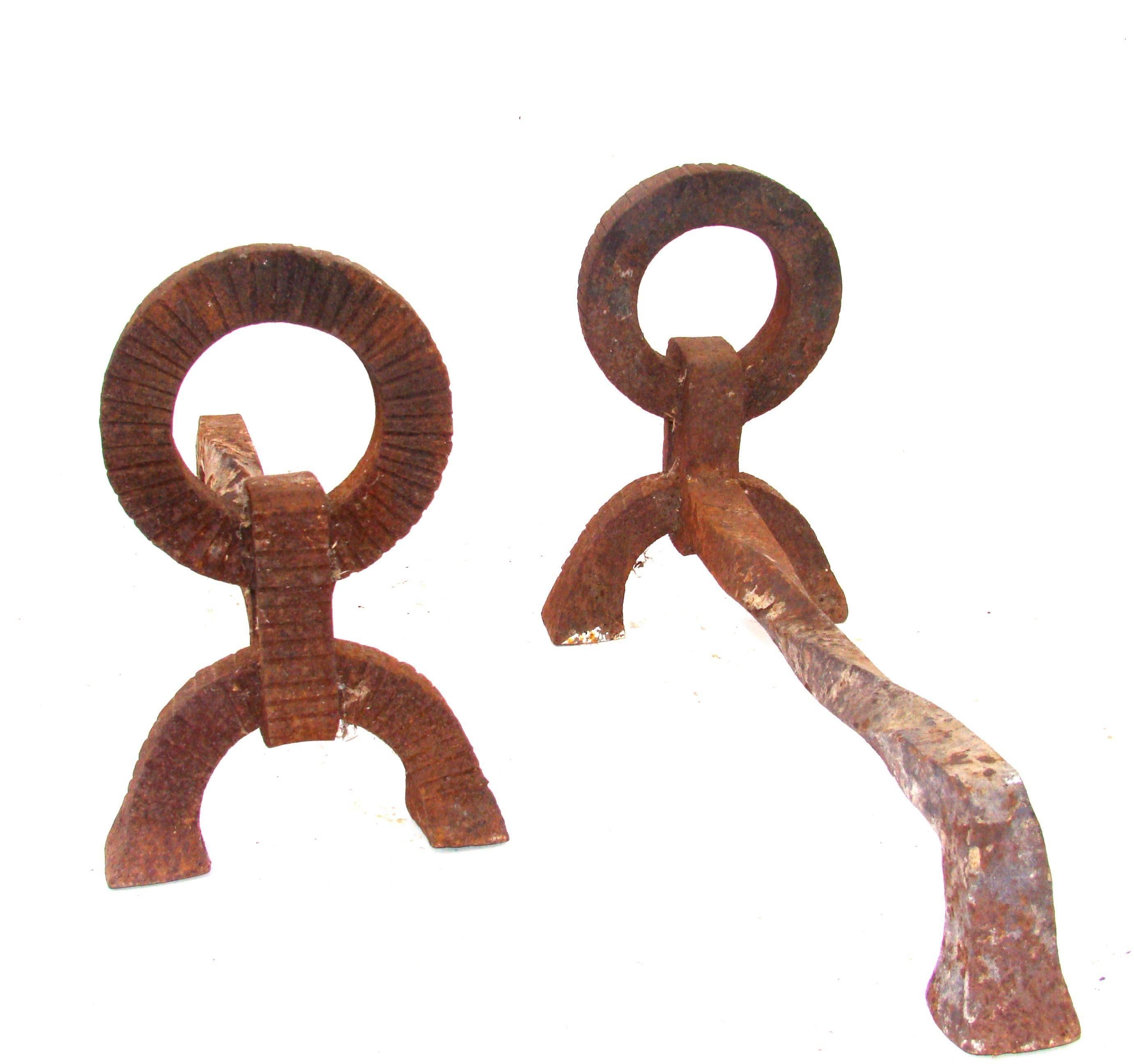 Pair of French wrought iron andirons by Jacques Adnet (Compagnie des Arts Français), circa 1940. Decorated with a large ring pattern with ridges.
