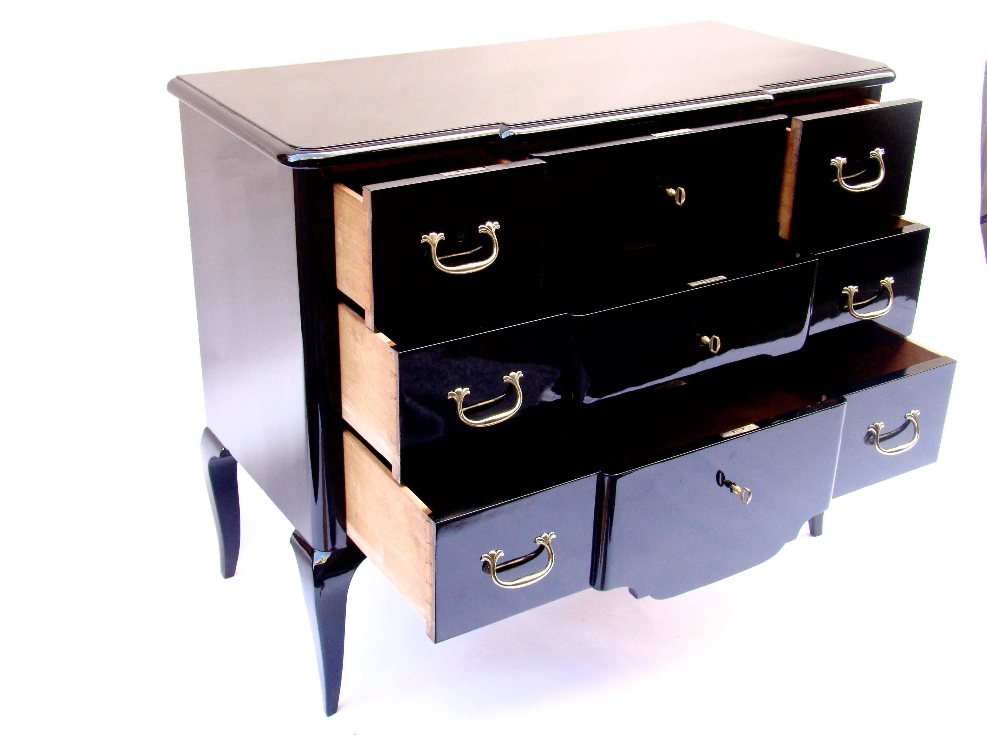 Handsome lacquered Commode by Maison Carlhian with gold bronze locks and handles including three drawers. Only the first one is composed of three separated compartments.
