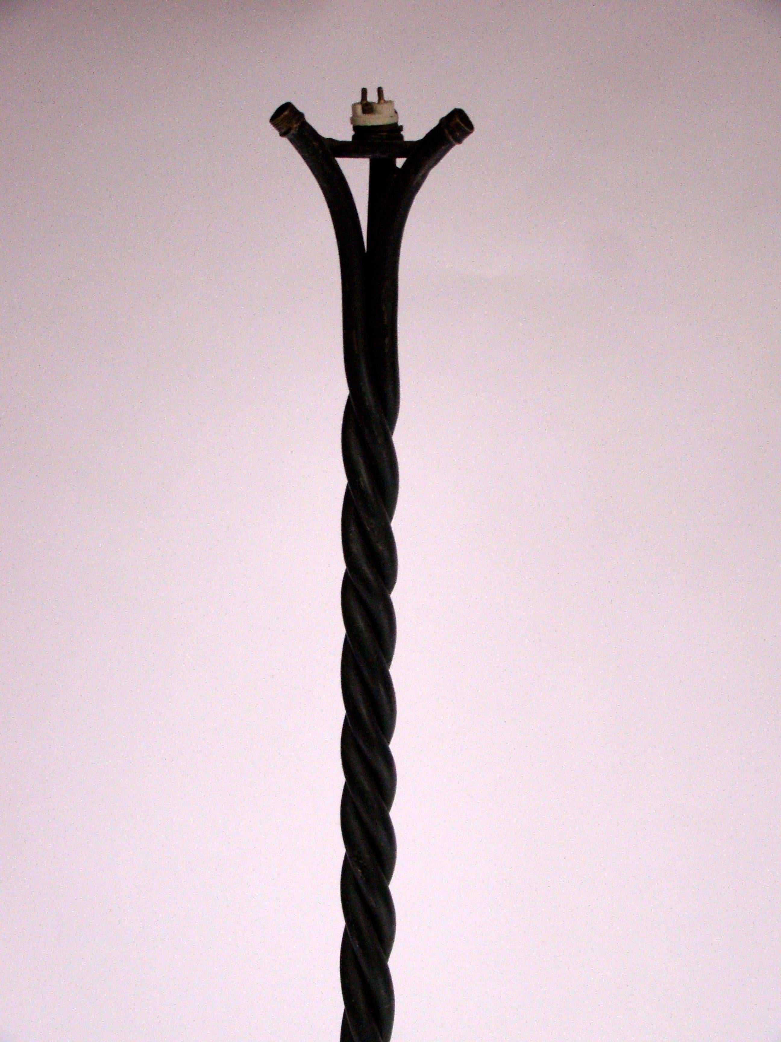 Original twisted floor lamp in burnished black wrought iron, circa 1960.