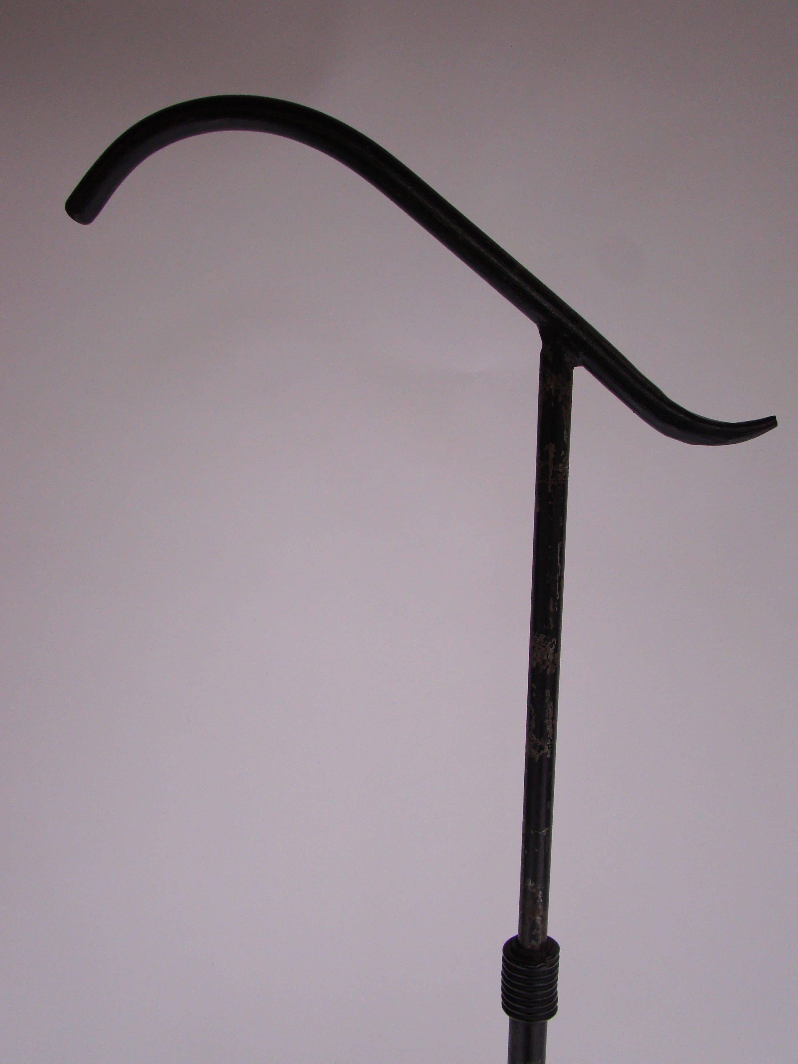 French floor lamp in burnished black wrought iron, circa 1960.