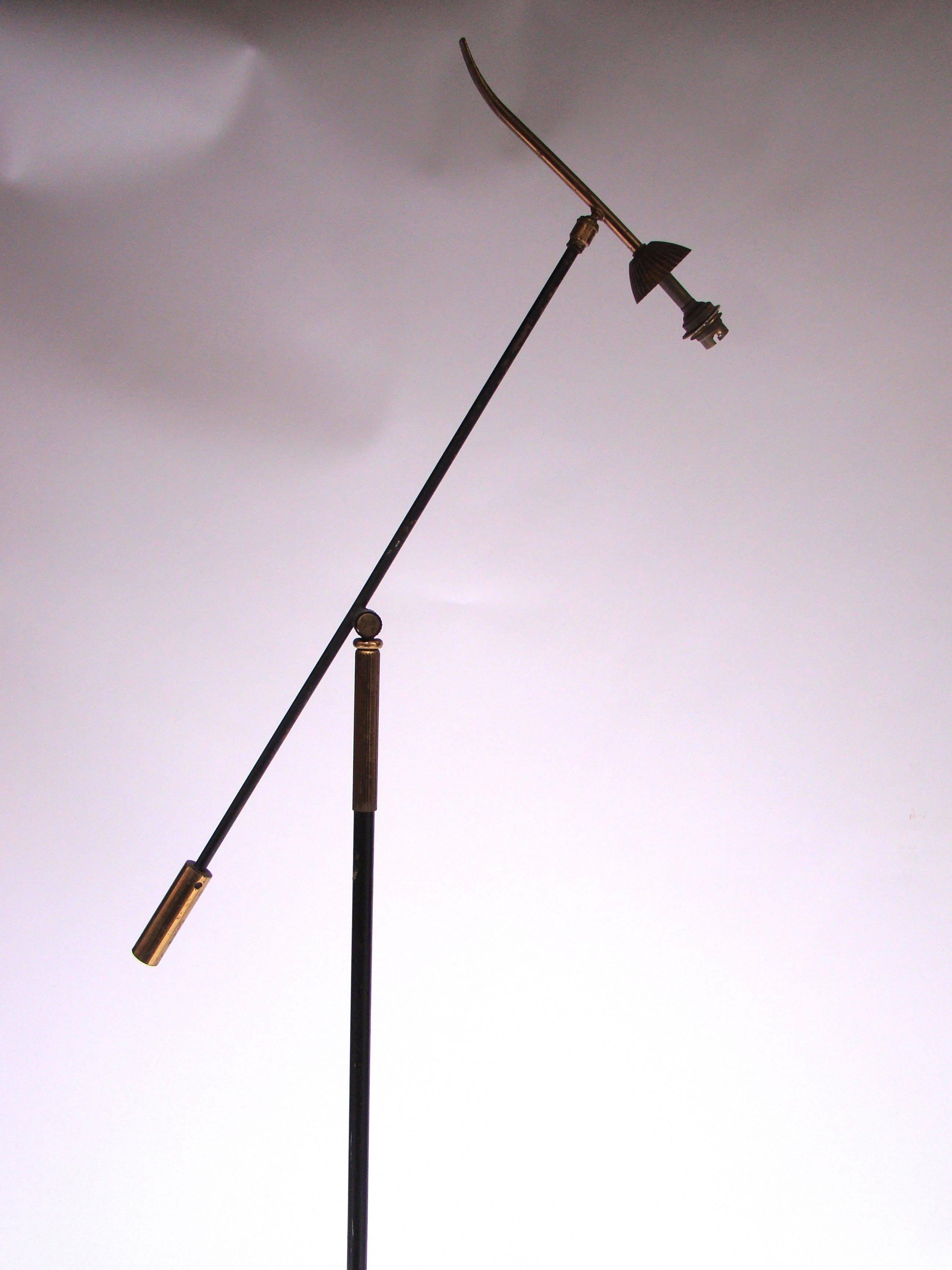 French floor lamp in golden and burnished black wrought iron with a rocker arm, circa 1950.