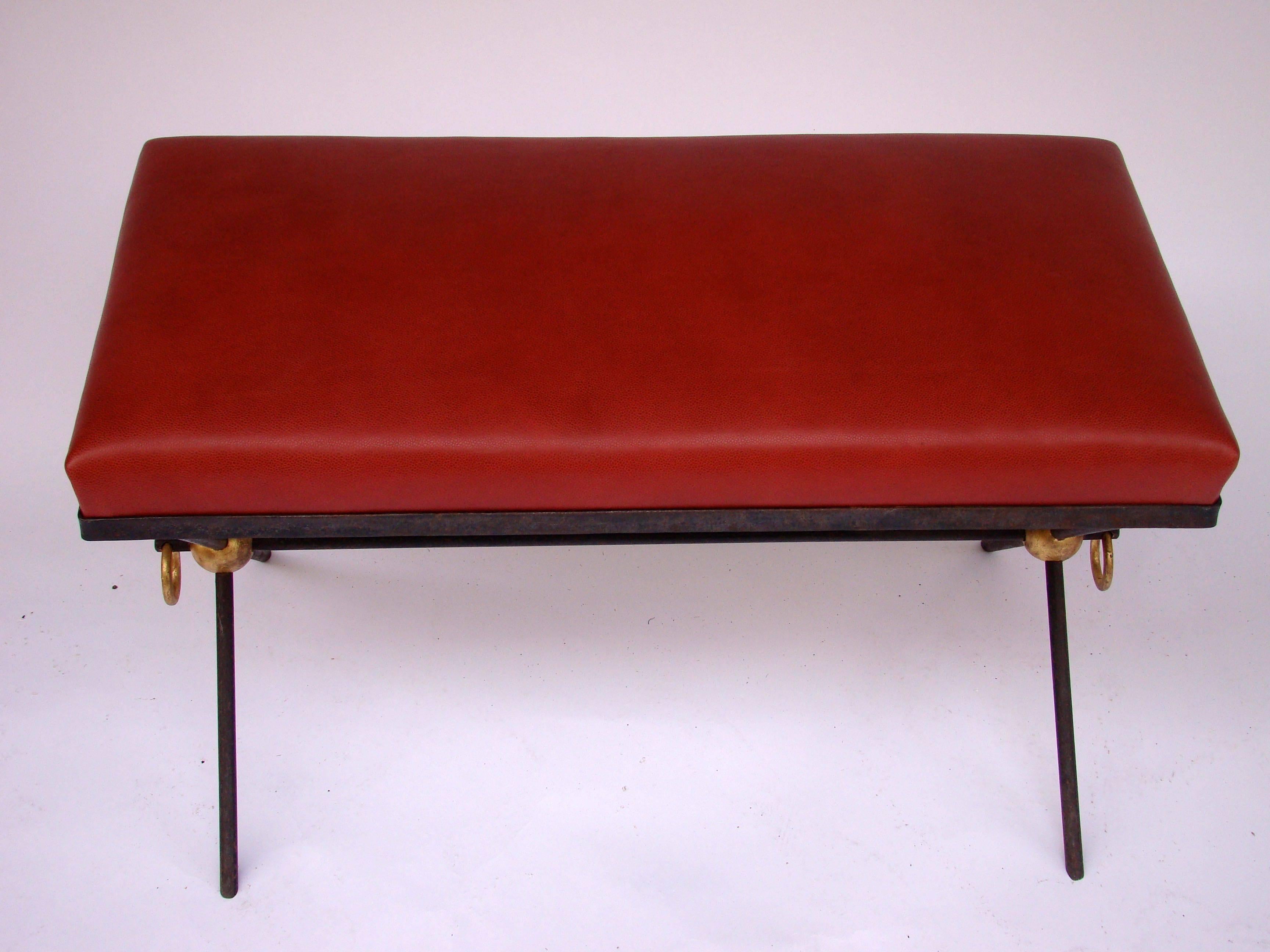 Elegant bench in black and golden lacquered wrought iron with a red leather seat top, circa 1940.