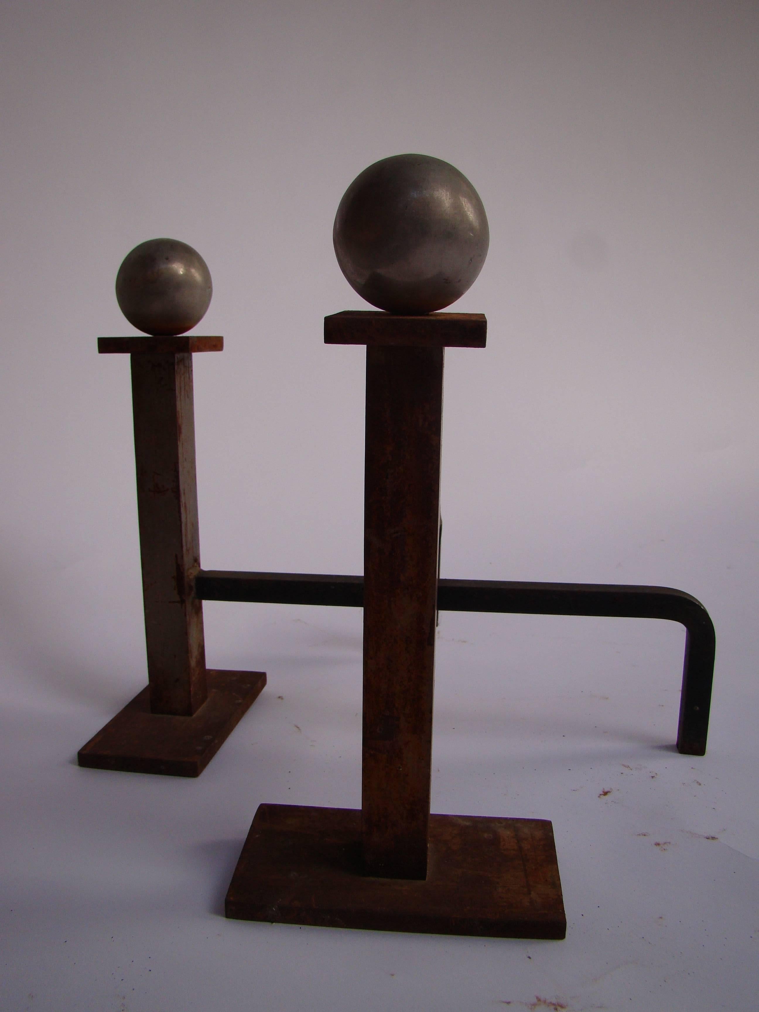 Pair of andirons by Jacques Adnet 
1940
Measure: Height 32 cm
Diameter 39 cm.
 