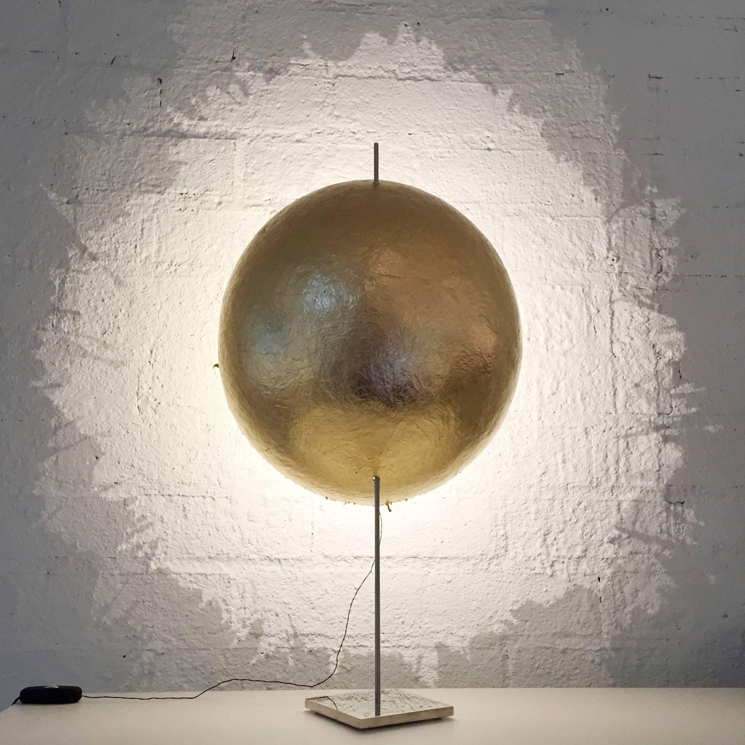 LED table lamp with nickel-plated copper structure and hand formed natural fiberglass shaded finished in gold leaf with uneven edges casting unique shadow lines, available from showroom display. 
Dimensions: 15.75