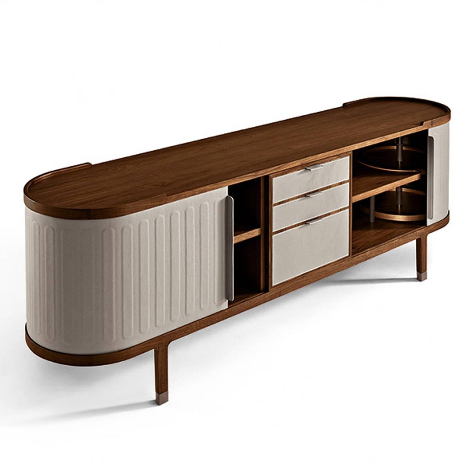 Cabinet by Chi Wing to for Giorgetti available from showroom display in solid walnut Canaletto wood wrapped in saddle leather. Pull sliding doors, self closing drawers and adjustable shelving with swivel trays included. Metal parts in painted