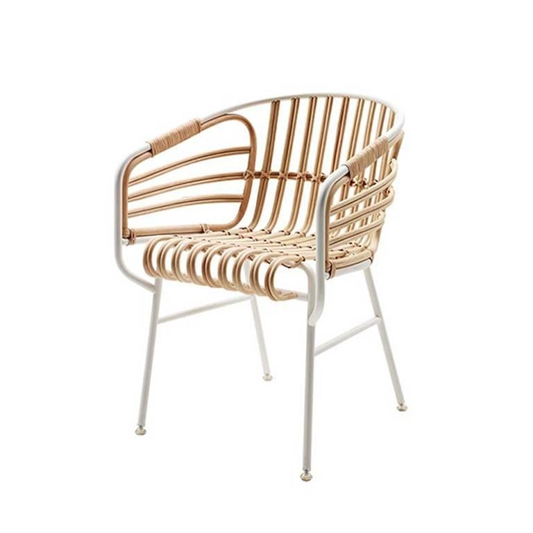 Outdoor dining chair available from showroom display with natural wicker and rattan shell. Structure embossed in white metal with nylon feet. 
Measures: Details: 21 1/2