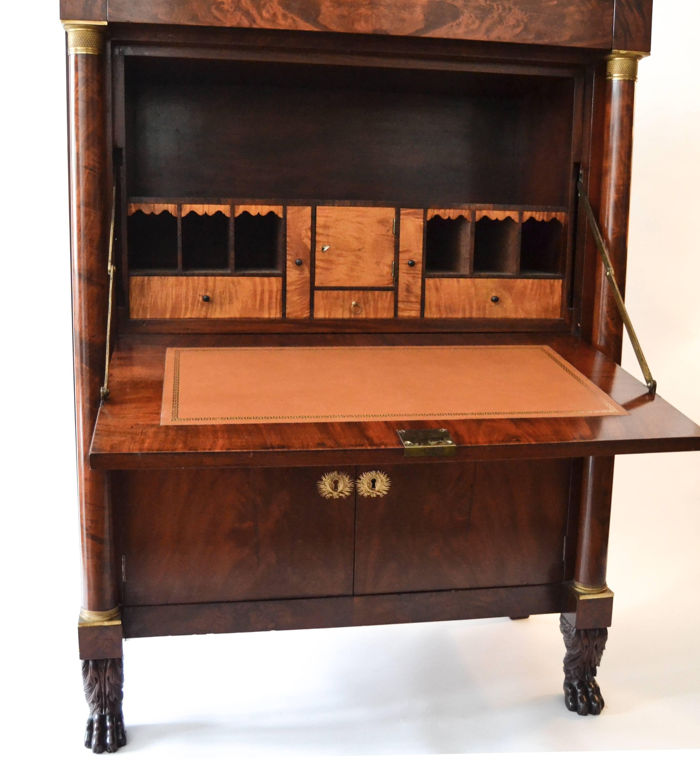 Fine New York classical secretary in the manner of Duncan Phyfe workshop. Finely carved solid mahogany paw feet, French ormolu, mahogany and satinwood veneers on interior drawer fronts. One interior drawer signed by owner (probably).
