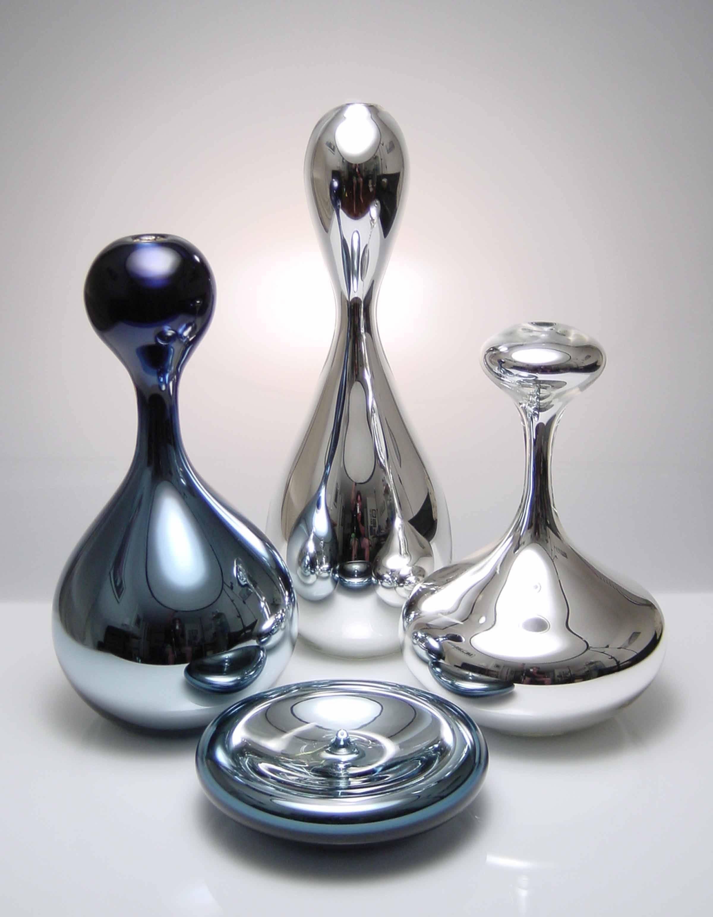 The Mercury Series is comprised of blown glass vessels with a mirrored interior. Meant to mimic the different stages of a drop of mercury separating, the set of handmade vessels is comprised of four pieces of varying colors and bubble