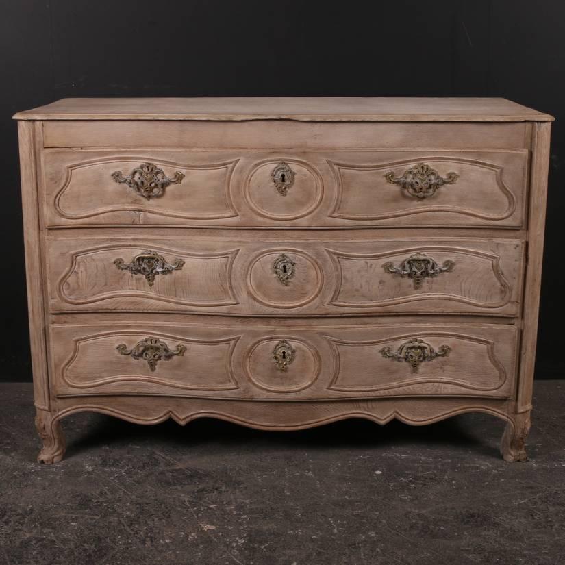 18th century French bleached oak commode with a serpentine front, 1780. 

Dimensions:
52.5 inches (133 cms) wide
24 inches (61 cms) deep
36 inches (91 cms) high.

       
