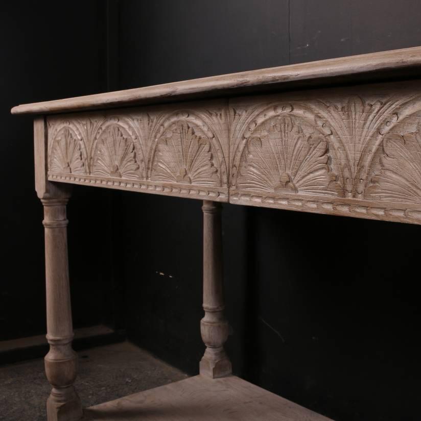 19th century English carved oak two-drawer server with a bleached finish, 1860
 
Dimensions
60 inches (152 cms) wide
21 inches (53 cms) deep
32 inches (81 cms) high.

          