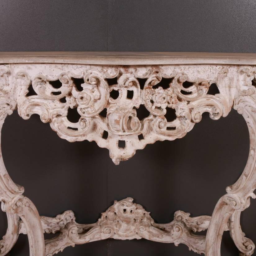 Late 19th century Italian carved wood console with original painted finish on the base and a faux stone painted top, 1880.

Dimensions
55.5 inches (141 cms) wide
15 inches (38 cms) deep
37 inches (94 cms) high.

      