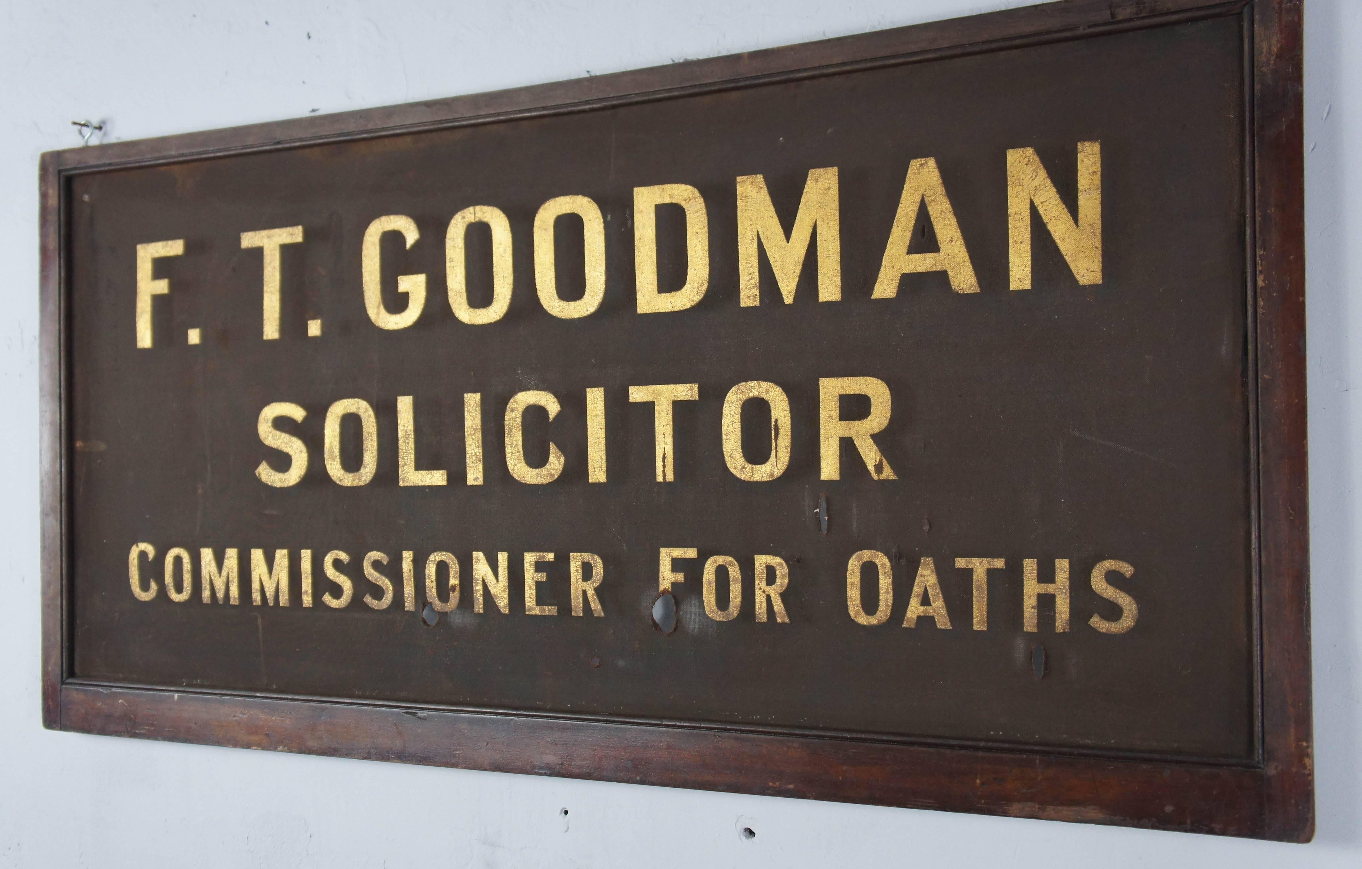 F. T Goodman Solicitors were in business from 1879-1916, so this sign has good age to it. It features beautiful gold lettering on a wire mesh background, surrounded by a wooden frame. There are a few smallish holes on bottom line of writing.